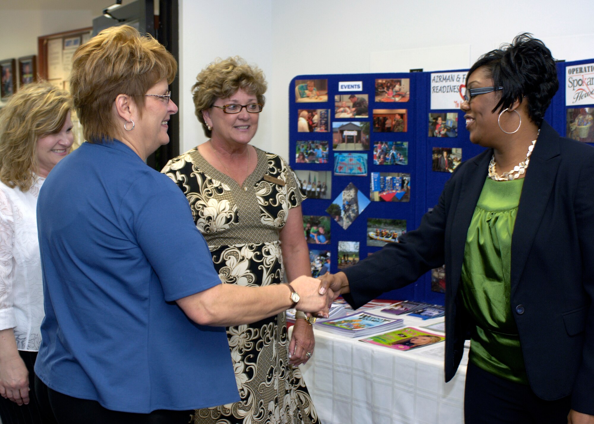 FAIRCHILD AIR FORCE BASE, Wash. – Javonika McCree, Airman & Family Readiness Center community readiness technician, welcome Chris Lichte, wife of Air Mobility Command commander Gen. Arthur Lichte, and Laurie Sharpy, wife of 92nd Air Refueling Wing commander Col. Thomas Sharpy, to the A&FRC May 19. Linda Miles, A&FRC director, escorted the visitors through the building highlighting programs offered to Airmen. (U.S. Air force photo / Airman 1st Class Melissa Barnett)