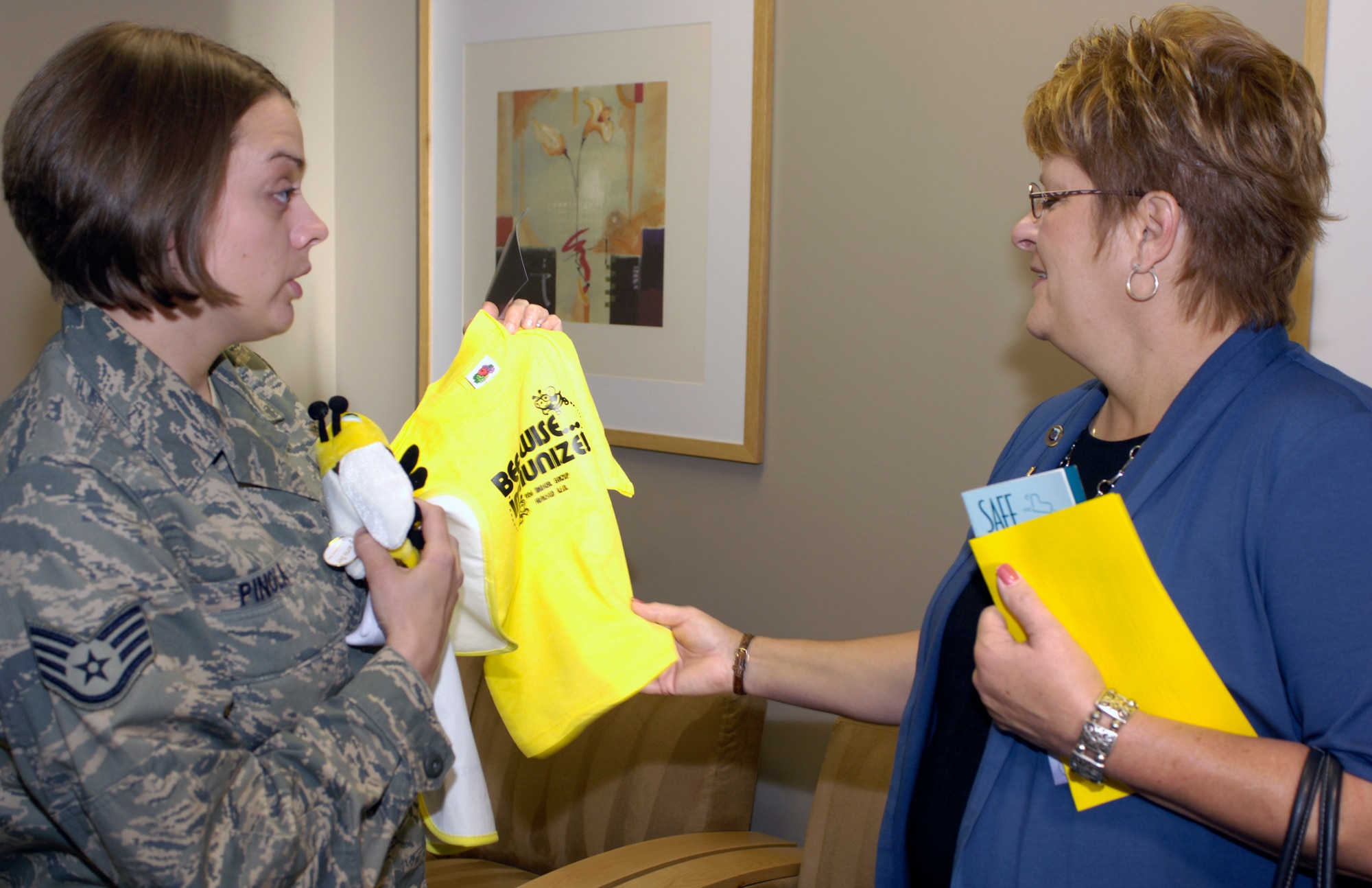 FAIRCHILD AIR FORCE BASE, Wash. – Staff Sgt. Amanda Pinola, 92nd Medical Operations Squadron, presents souvenirs to Chris Lichte, wife of Air Mobility Command commander Gen. Arthur Lichte, during a visit to the 92nd Medical Group May 19. The tour included visits to Mental Health, Family Advocacy, Immunizations, Pediatrics and the Women’s Health Clinic. (U.S. Air Force photo / Airman 1st Class Melissa Barnett)