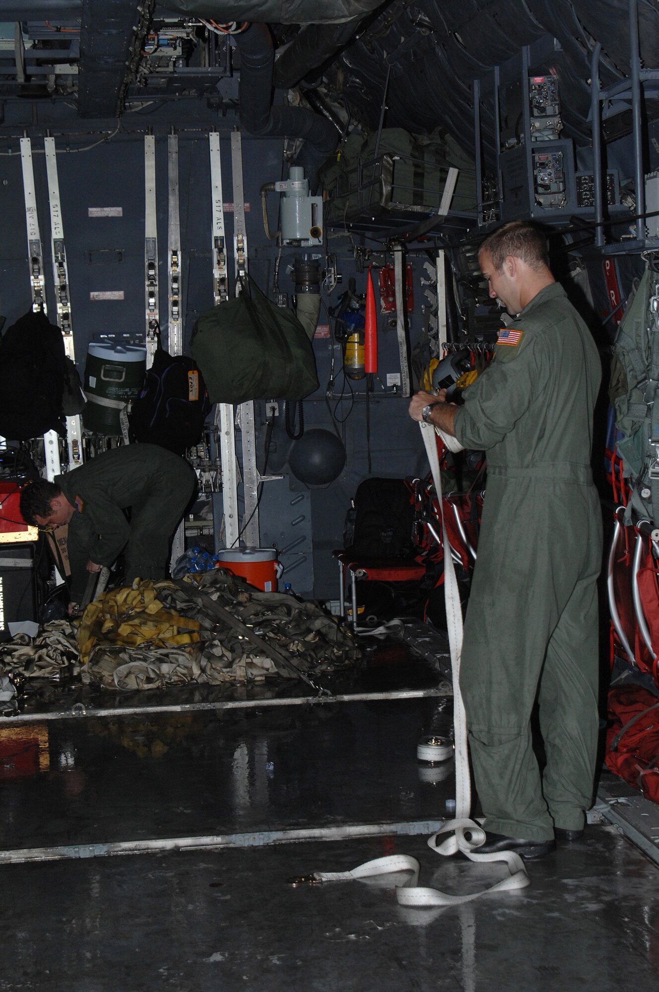 YANGON, Burma--  1st Lt. Buckley Kowslowski and Senior Airman Stuie Hopson prepare a U.S. Air Force C-130 Hercules for return to Utapao, Thailand after the delivery of 15,000 lbs of humanitarian relief supplies to Burma May 19. Capt Kowslowski and Airman Hopson are with the 374th Airlift Wing from Yokota AB, Japan. The Airmen are deployed in support of Operation Caring Response. (U.S. Air Force photo by Senior Airman Sonya Croston)