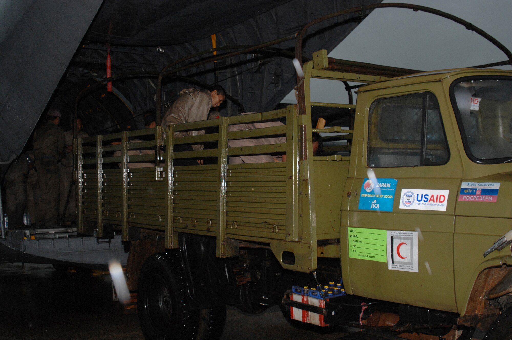 YANGON, Burma--  Burmese military members load a truck with bottles of water from a U.S. Air Force C-130 Hercules May 19. Approximately 15,000 lbs of water, water containers and mosquito netting were unloaded at Yangon International Airport. The Airmen are deployed in support of Operation Caring Response. (U.S. Air Force photo by Senior Airman Sonya Croston)