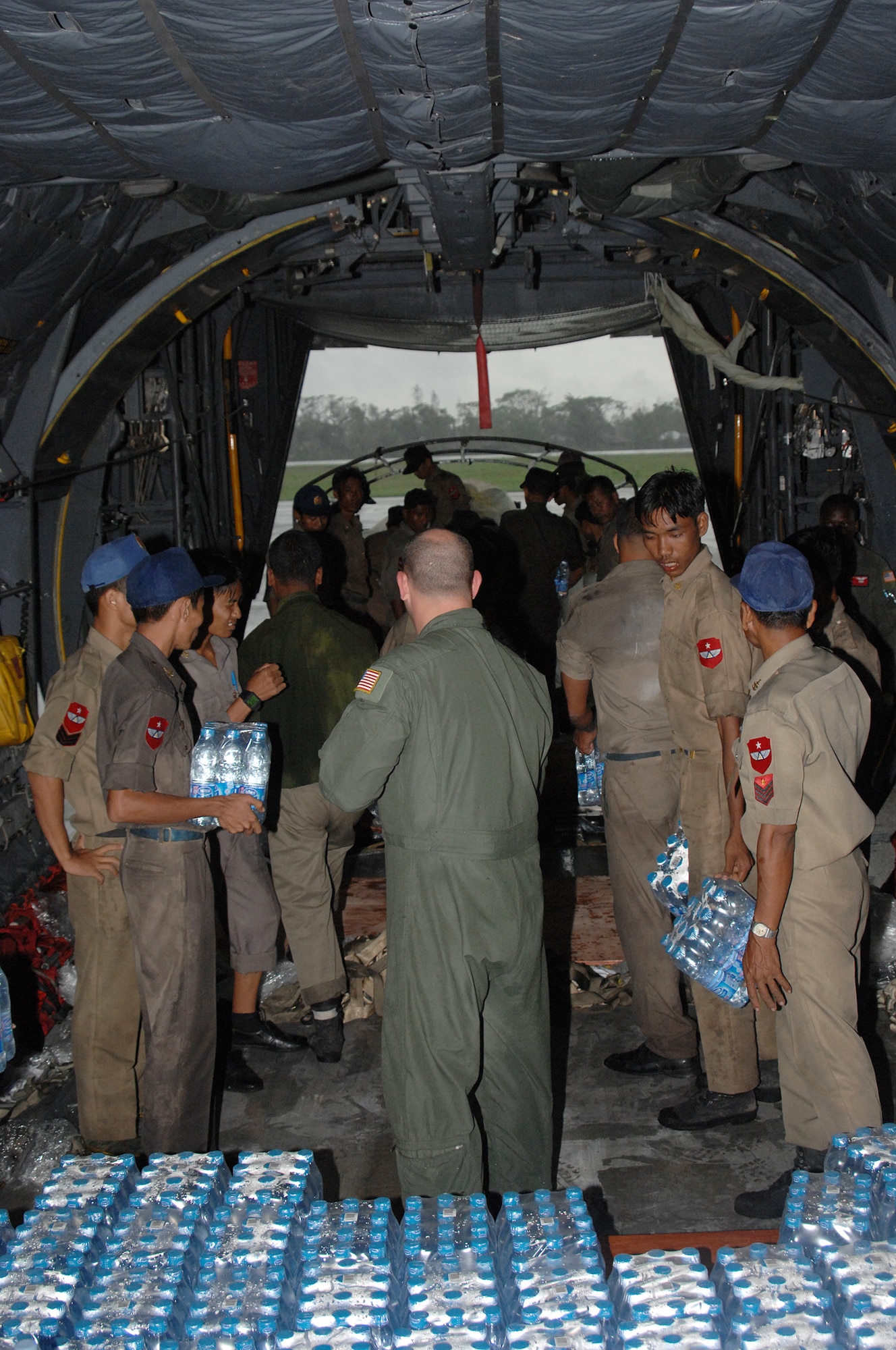 YANGON, Burma-- U.S. Air Force personnel provided an additional delivery of approximately 15,000 lbs. of humanitarian relief supplies containing water, water containers and mosquito netting May 19 to Yangon International Airport after Cyclone Nargis struck on May 2.. The Airmen are deployed in support of Operation Caring Response. (U.S. Air Force photo by Senior Airman Sonya Croston)