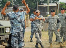 SOTO CANO AIR BASE, Honduras--Army Sgt. Manuel Perez-Hernandez guides a Honduran National Police Academy cadet through a high-risk traffic stop exercise here May 16 during a subject matter exchange between Joint Task Force-Bravo?s Joint Security Forces personnel and more than two dozen cadets. The information exchanges have provided instruction to more than 1,200 Honduran military and police personnel annually. (U.S. Air Force photo by Tech. Sgt. William Farrow)