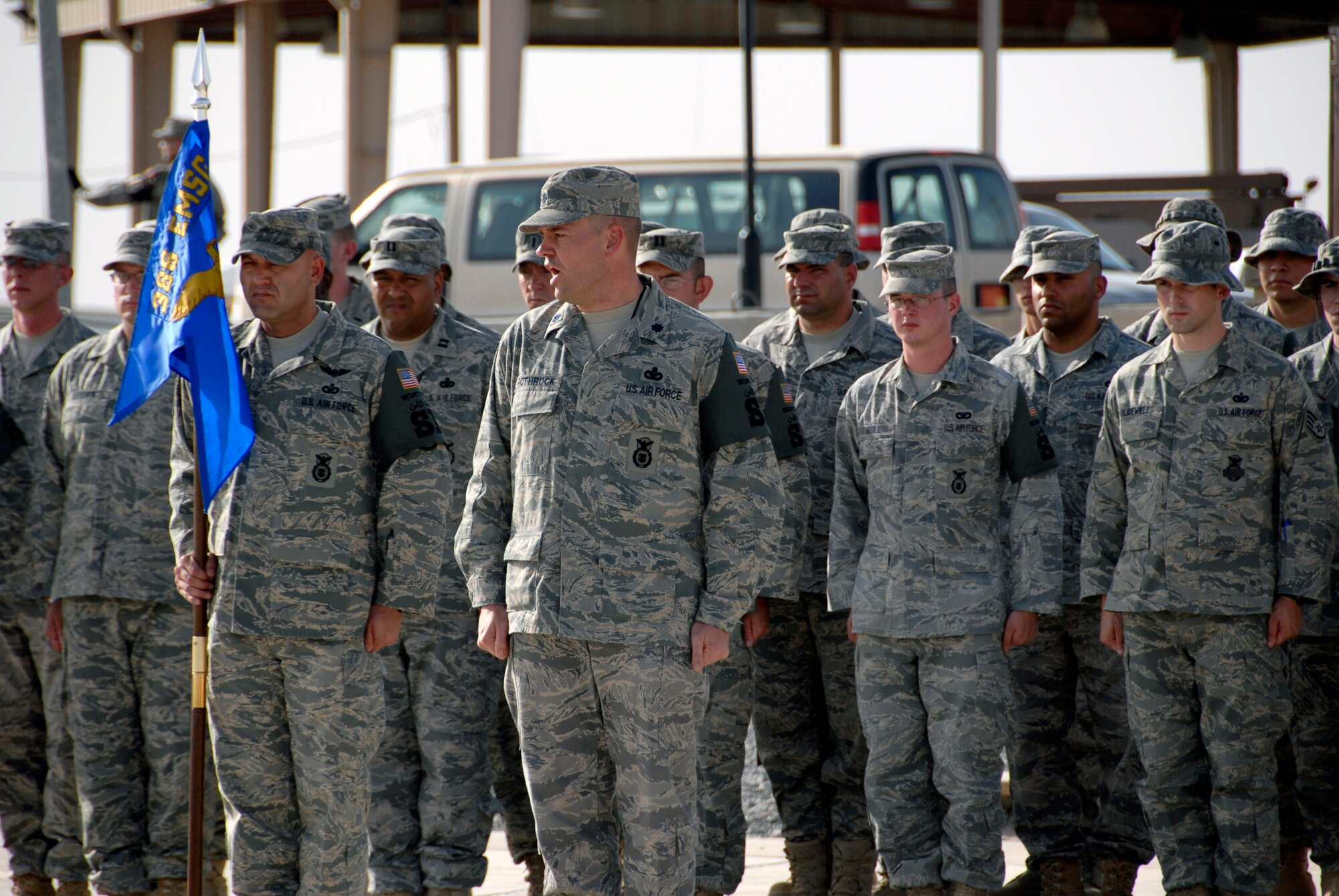 Lt. Col. Martin Rothrock issues the command "Present, Arms" to the formation in an expedited retreat ceremony during National Police Week May 16 at an air base in Southwest Asia. The 386th ESFS members commemorated National Police Week May 11 through 17 hosting a series of events to celebrate the memory of their fallen comrades. Colonel Rothrock is the 386th Expeditionary Security Forces Squadron commander. (U.S. Air Force photo/Staff Sgt. Patrick Dixon) 
