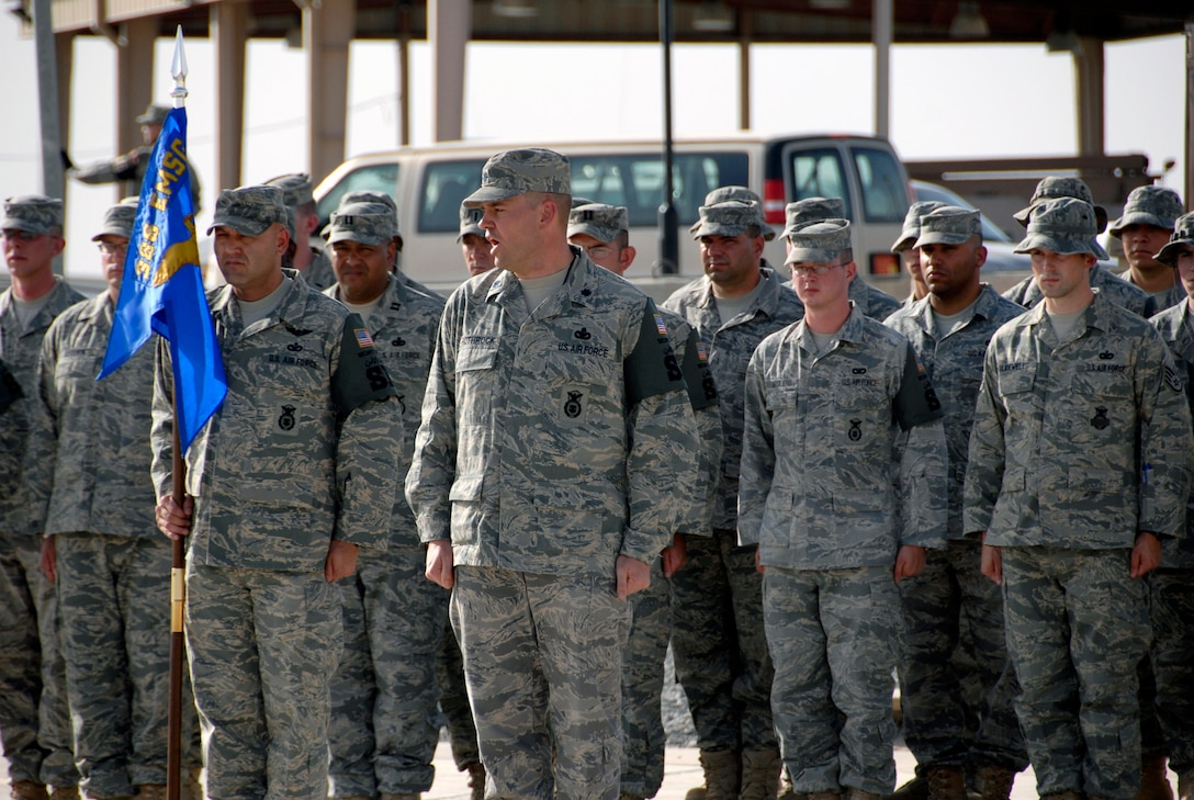 Lt. Col. Martin Rothrock issues the command "Present, Arms" to the formation in an expedited retreat ceremony during National Police Week May 16 at an air base in Southwest Asia. The 386th ESFS members commemorated National Police Week May 11 through 17 hosting a series of events to celebrate the memory of their fallen comrades. Colonel Rothrock is the 386th Expeditionary Security Forces Squadron commander. (U.S. Air Force photo/Staff Sgt. Patrick Dixon) 
