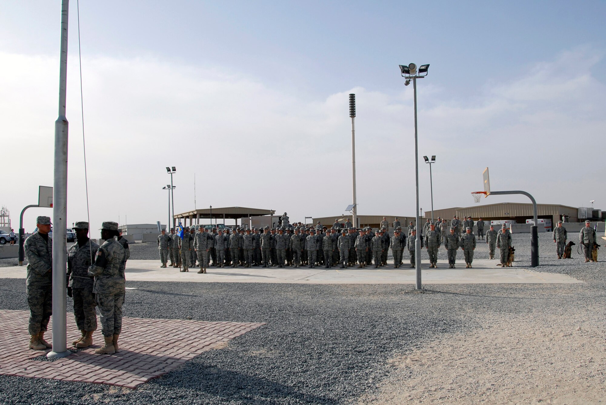 Airmen from the 386th Expeditionary Security Forces Squadron stand at attention in an expedited retreat ceremony during National Police Week May 16 at an air base in Southwest Asia. The 386th ESFS members commemorated National Police Week May 11 through 17 hosting a series of events to celebrate the memory of their fallen comrades. (U.S. Air Force photo/Staff Sgt. Patrick Dixon) 
