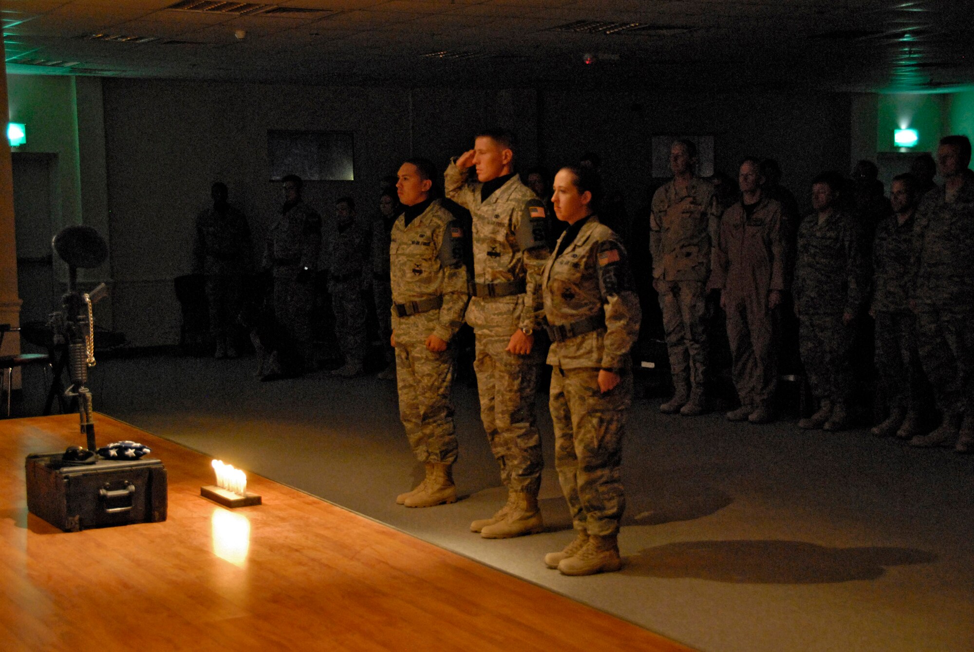 A member of the 386th Expeditionary Security Forces Squadron flag detail renders a salute to a memorial during a candle light vigil May 13 at an air base in Southwest Asia. The candlelight vigil was a memorial service designated to pay homage to law enforcement officers who selflessly gave their lives in the line of duty during the past year including Air Force Office of Special Investigation special agents, security forces members and military working dogs. (U.S. Air Force photo/Capt. Jason McCree) 