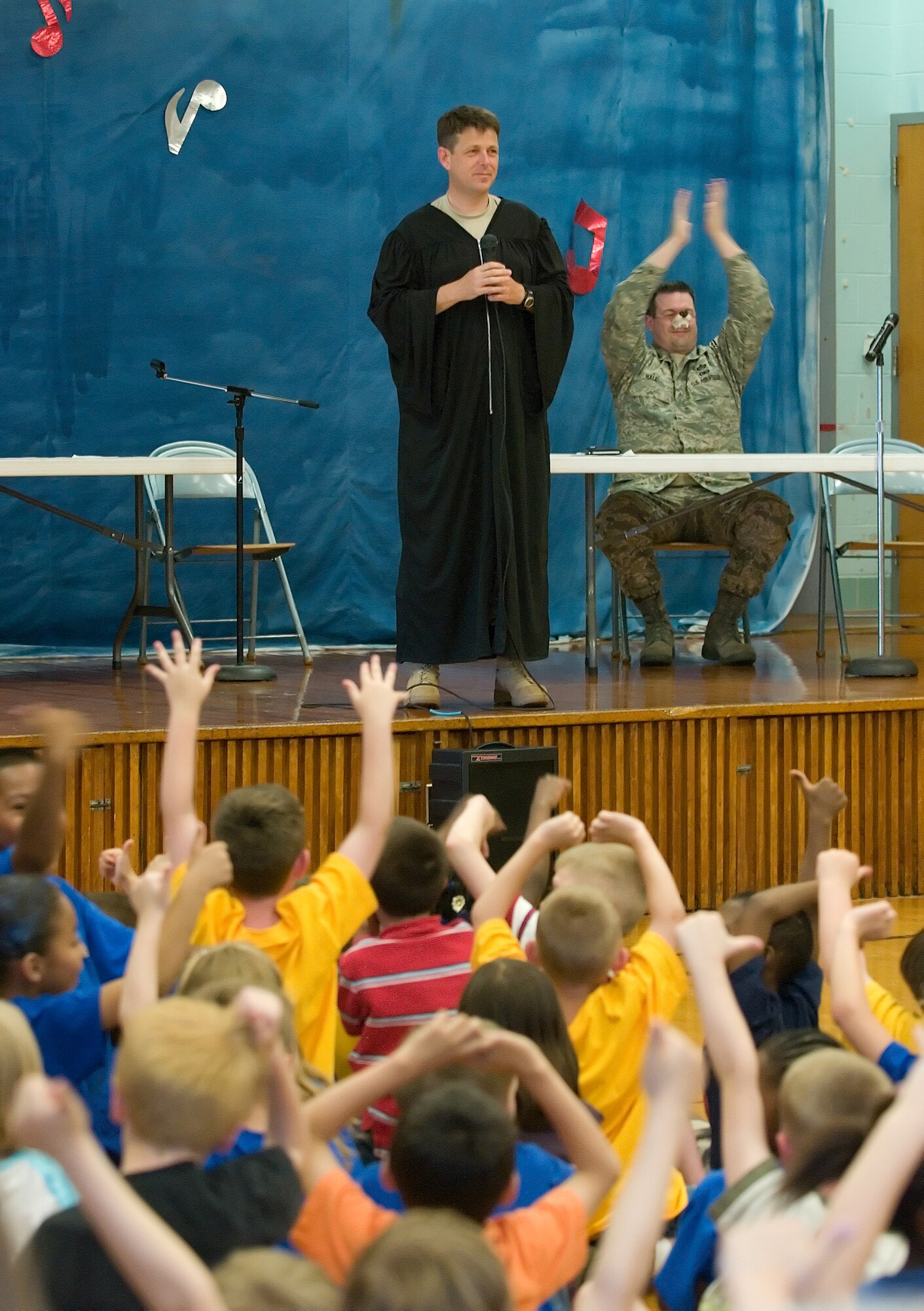 Lt. Col. Wes Moore, 436th Airlift Wing Staff Judge Advocate, asks the jury to render their verdict through cheering in a mock trial May 2 at Maj. George S. Welch Elementary School.  The Big Bad Wolf, played by Master Sgt. Darren Hall, 436th AW Legal Office superintendent, encourages the jury to rule in his favor.  (U.S. Air Force Photo/Jason Minto)