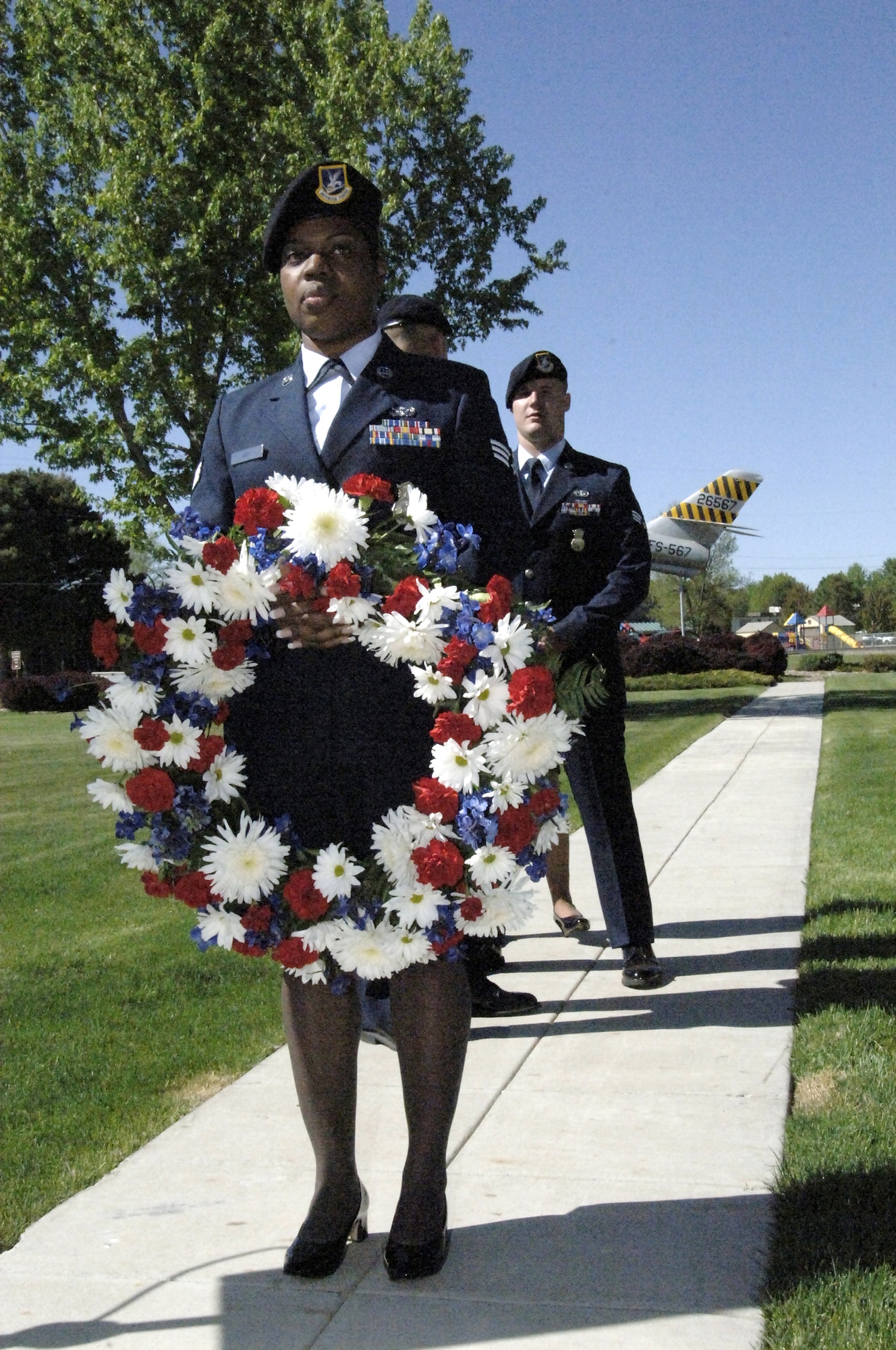 MOUNTAIN HOME AIR FORCE BASE, Idaho – Senior Airman Shleah Gay, 366th Security Forces Squadron, prepares to lay a wreath at the base of the flagpole in honor of fallen security forces members and law enforcement officials during a retreat ceremony May 15 for National Police Week. The week was to honor personnel in law enforcement and pay tribute to those who gave their lives while serving their community. (U.S. Air Force photo/ Staff Sgt. Brian Stives)