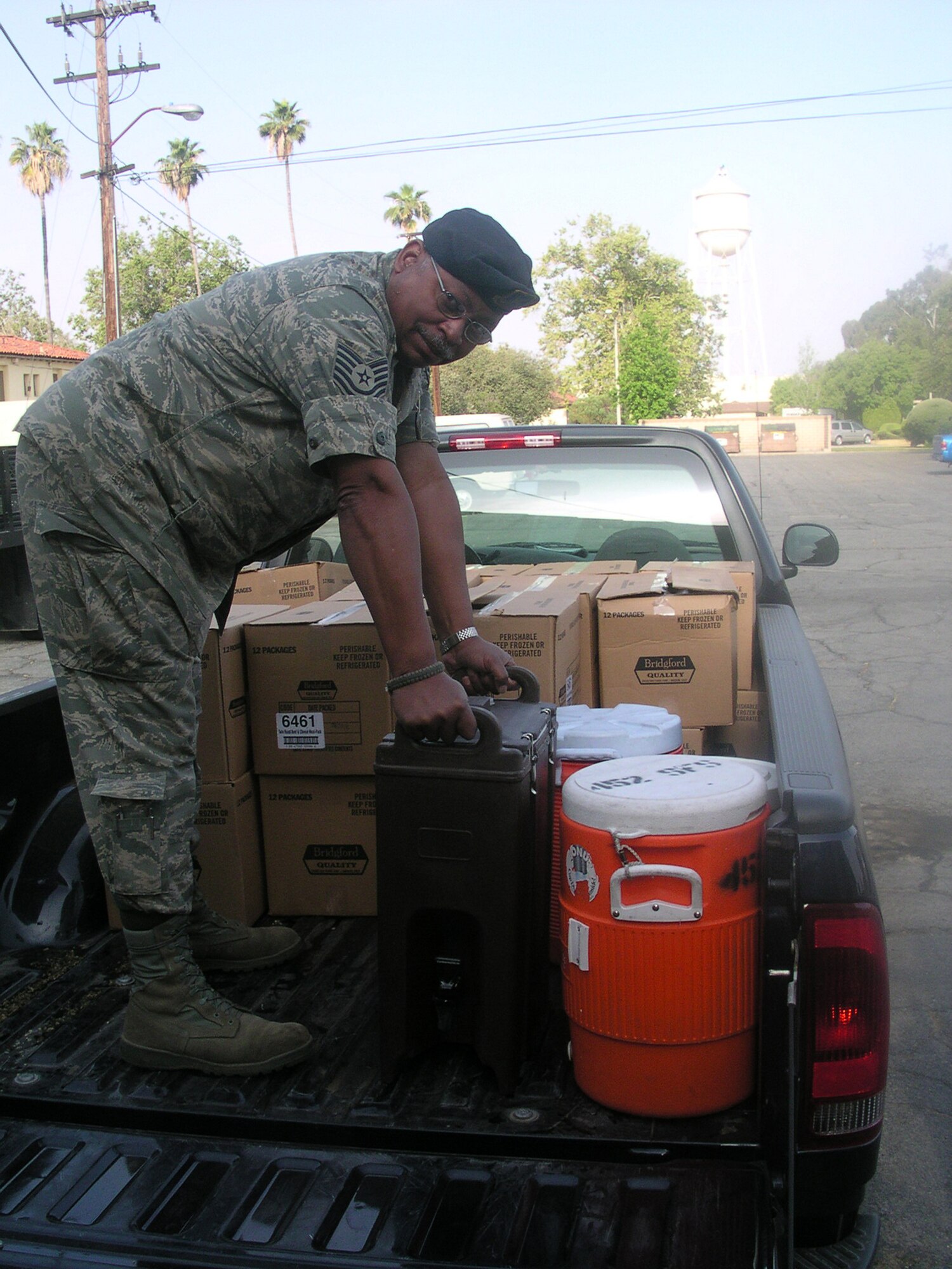 WRIGHT-PATTERSON AFB, Ohio - Tech Sgt. Mike Pennington, 445th Security Forces Squadron, off-loads food and drink for the troops during the Thunder Over the Empire Air Show at March Air Reserve Base, Calif. (Courtesy photo) 