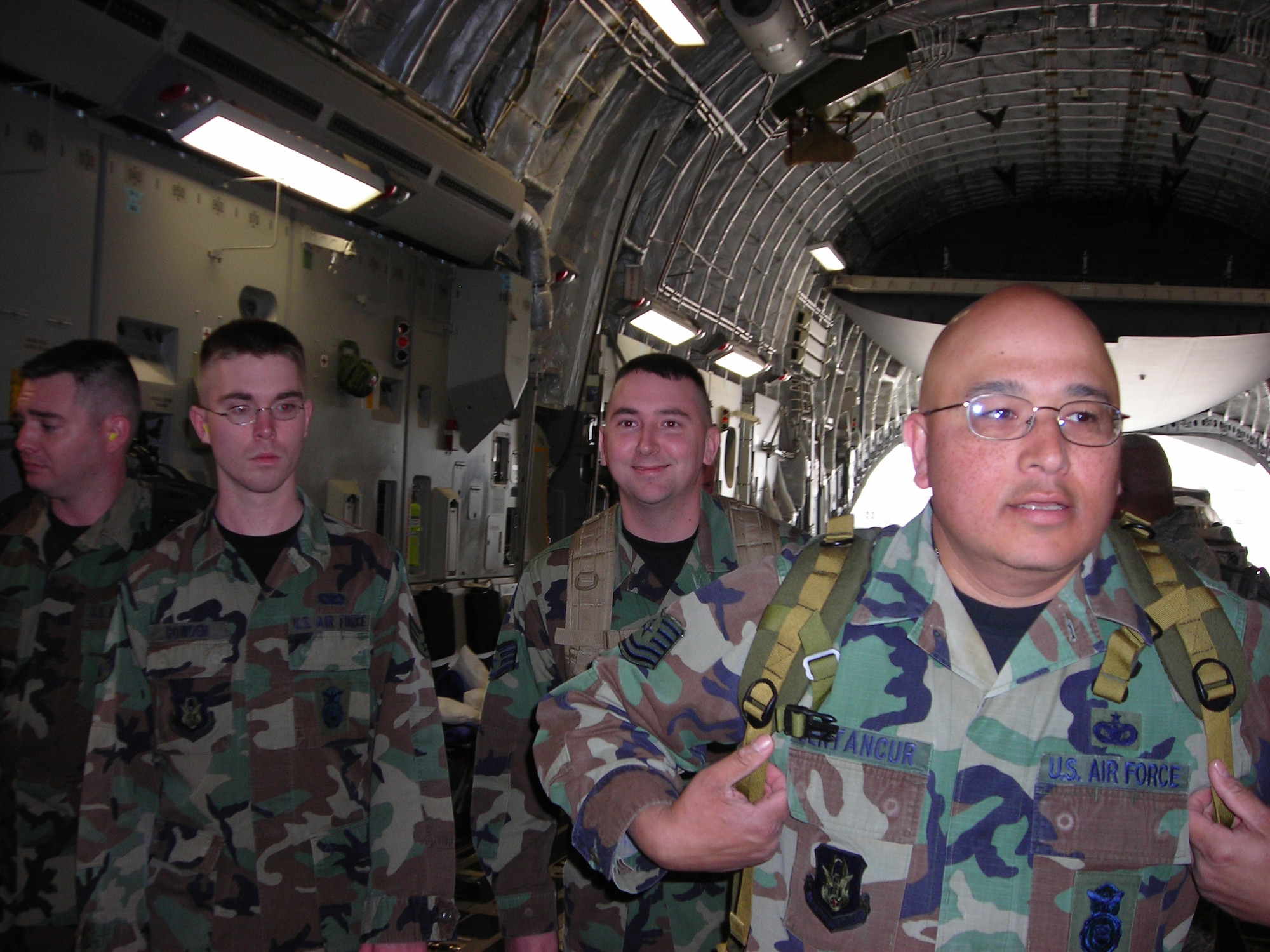 WRIGHT-PATTERSON AFB, Ohio - Reservists from the 445th Security Forces Squadron, from left, Senior Airman William Bowden, Staff Sgt. John Brinker, Staff Sgt. Jarrod Applegate, and Tech. Sgt. Daniel Bentancur, walk onto a C-17 from March Air Reserve Base, Calif.  The Airmen augmented existing security forces during the March ARB Air Show. (Courtesy photo) 