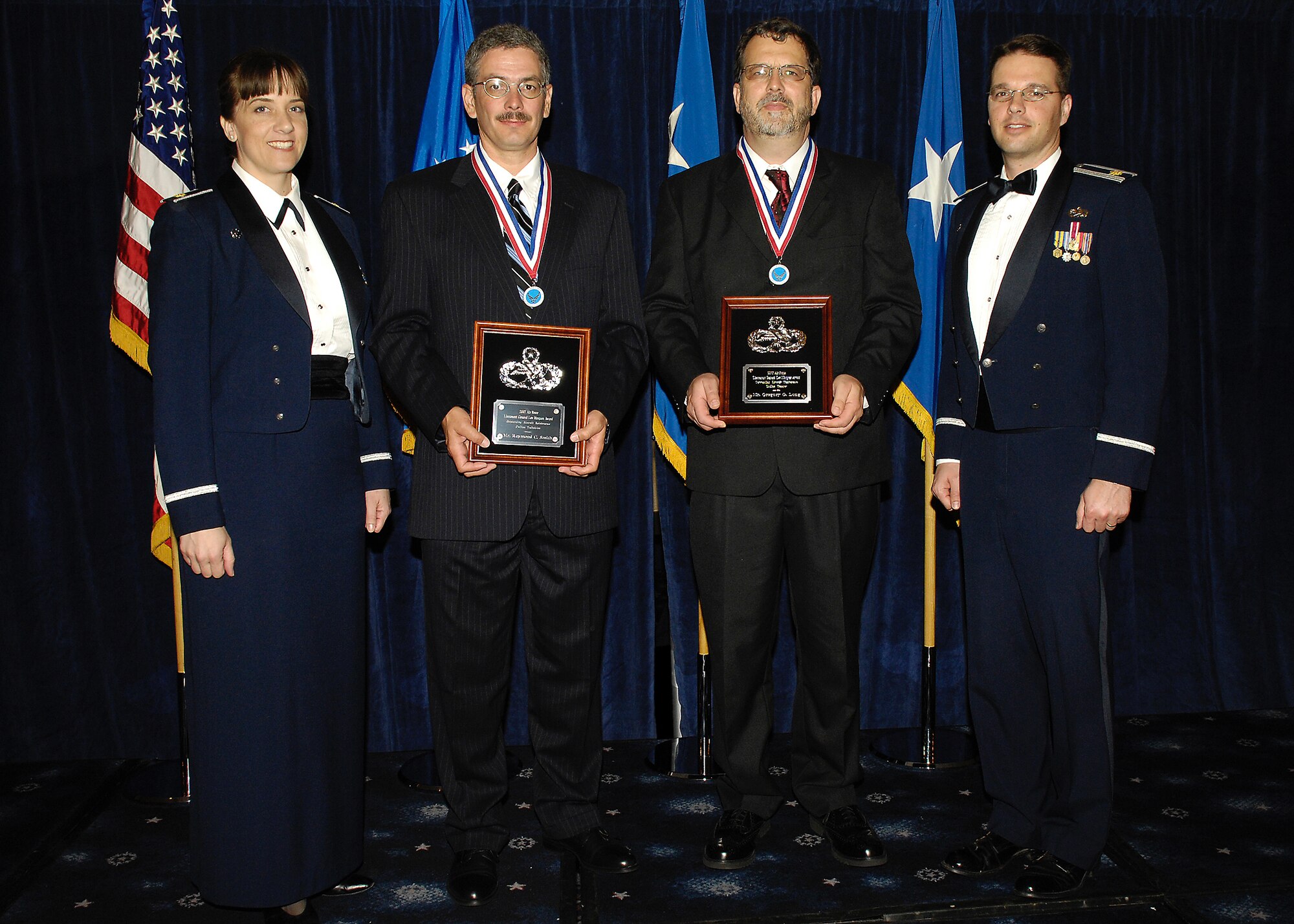 From left:  Maj. Stephanie Halcrow, 436th Maintenance Squadron commander, Raymond Smith, 436th Aircraft Maintenance Squaddron, Greg Long, 436th MXS; and Maj. David Glass, 436th AMXS commander, stop for a photograph following the presentatin of the Lt. Gen. Leo Marquez Award for 2007.  Mr. Long and Mr. Smith were presented the award by General (ret.) Marquez at a ceremony at Bolling Air Force Base May 1.  (U.S. Air Force Photo/Donna Parry)