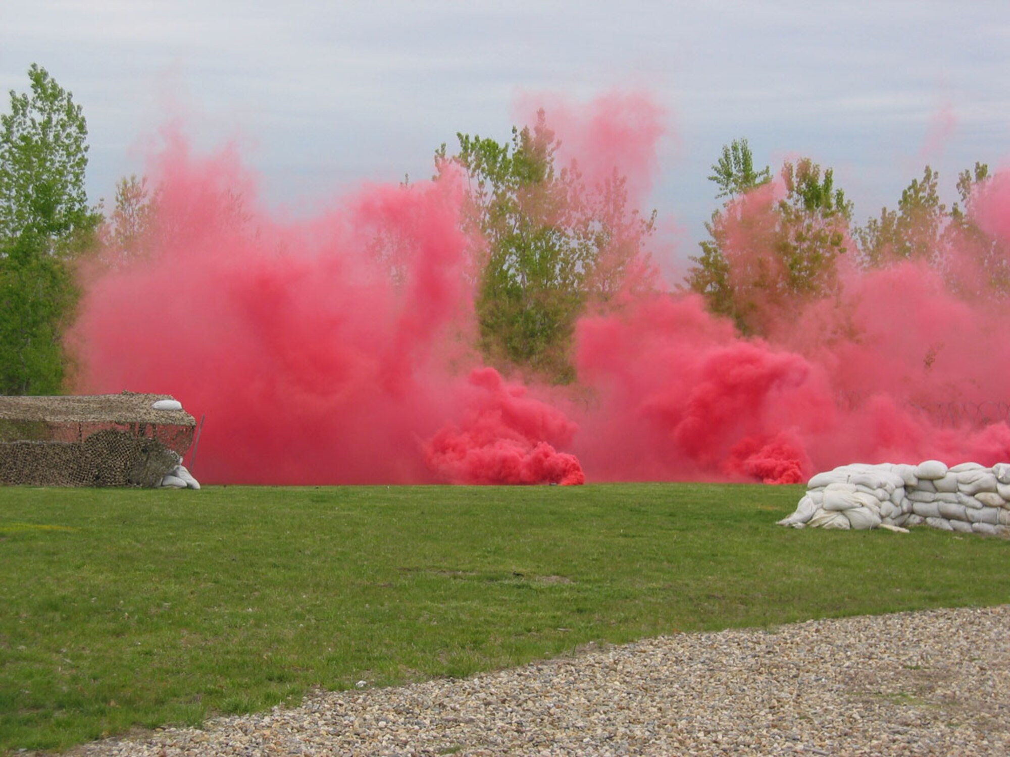 HANSCOM AFB, Mass. – Red smoke billows across Camp Patriot as part of a simulated chemical, biological, radiological, nuclear and high-yield explosive (CBRNE) weapons attack. The attack was part of a Base Readiness Exercise that took place here May 12 to 16, which tested Hanscom personnel and their ability to survive and operate in a field environment. (U.S. Air Force photo by Joe Lawlor.) 
