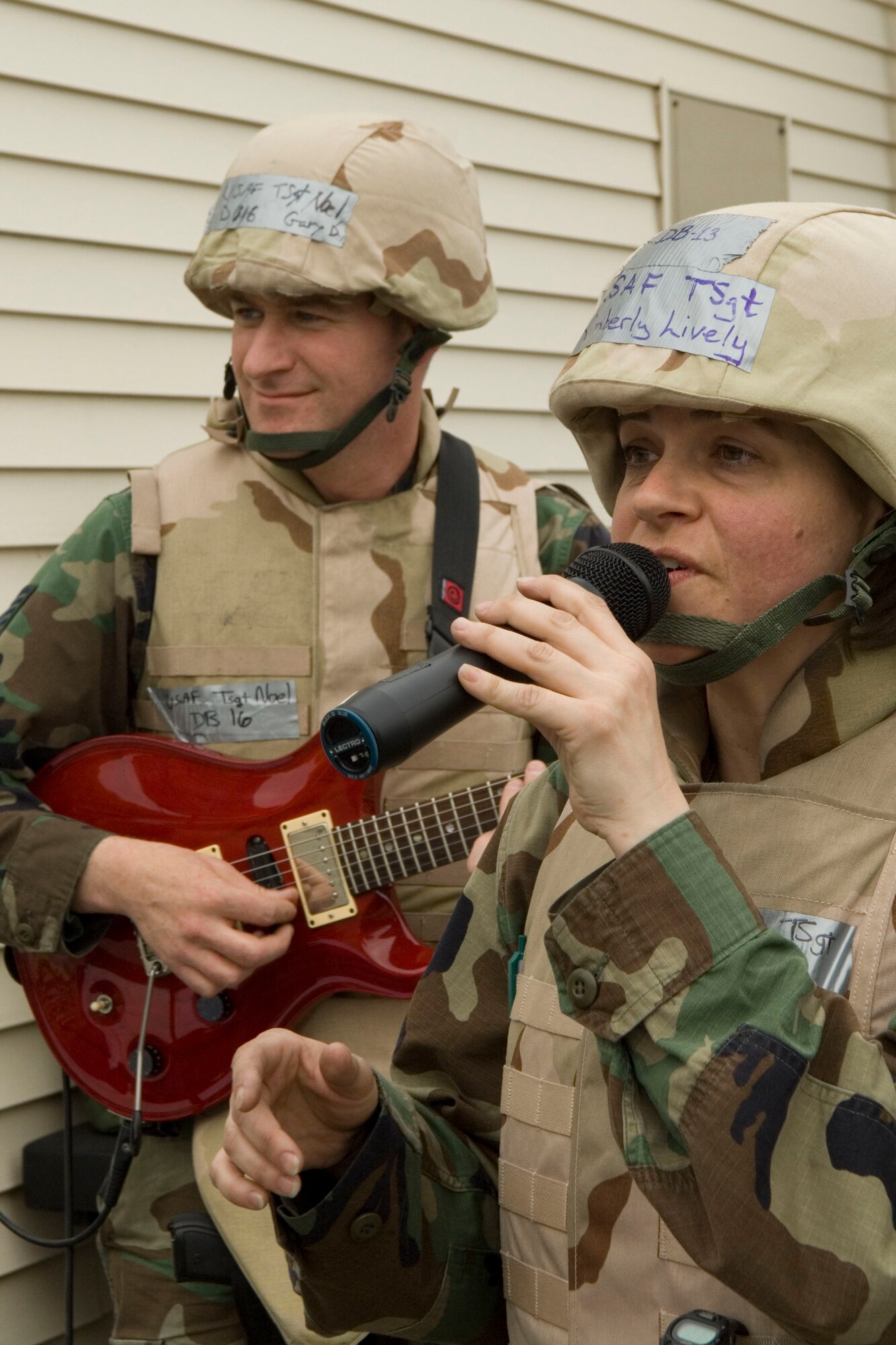 HANSCOM AFB, Mass. – Tech. Sgt. Kim Lively and Tech. Sgt. Gary Noel, both Air Force Band of Liberty members, perform a variety of songs at Camp Patriot as part of a Base Readiness Exercise here. The BRE, which took place here May 12 to 16, tested Hanscom personnel and their ability to survive and operate in a field environment. (U.S. Air Force photo by Rick Berry.)