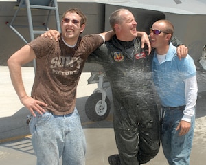 LANGLEY AIR FORCE BASE, Va. -- Col. Jay Pearsall, previous commander of the 192nd Fighter Wing, hugs his sons Erik (left) and Mike after completing his final flight in the F-22A Raptor May 15.  Military members, friends and family gathered on the flightline near the 94th Fighter Squadron to honor him for more than 25 years of service.  (U.S. Air Force photo/Master Sgt Carlos J. Claudio)