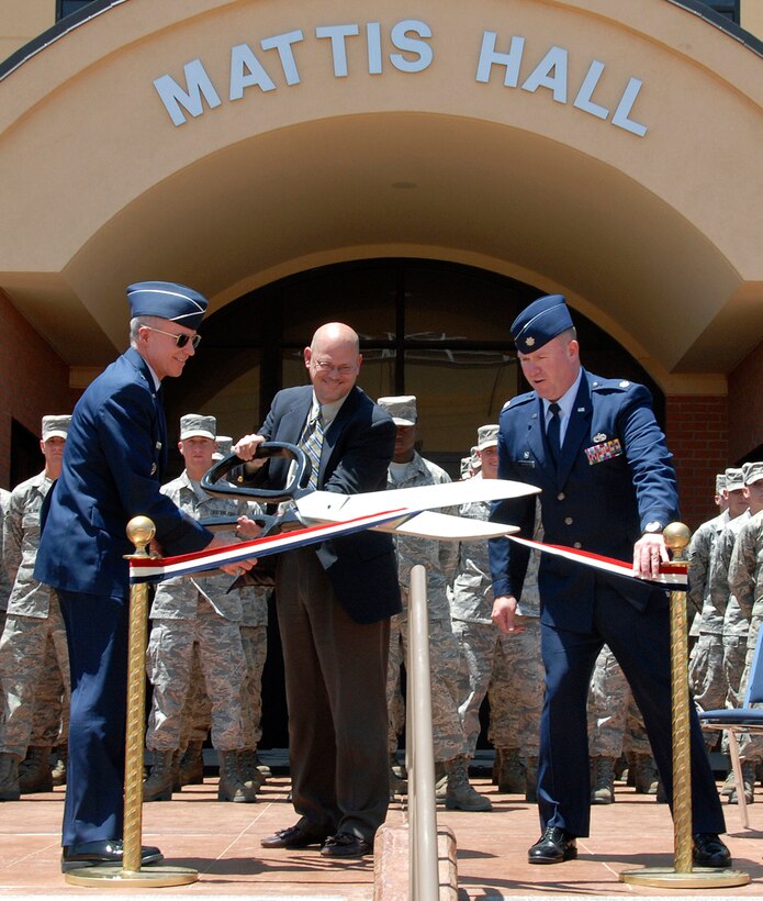 At the Mattis Hall dedication ceremony May 19 in honor of Capt. William Mattis, a fallen B-57 pilot, Brig. Gen. Richard Devereaux, the 82nd Training Wing commander, and Lt. Col. Thomas Ventriglia, the 363rd Training Squadron commander, assist Dr. Charles Mattis, the son of Captain Mattis, with cutting the ribbon. Mattis Hall is a new $27 million, 300-room dormitory for the 363rd Training Squadron. (U.S. Air Force photo/Mike Litteken)