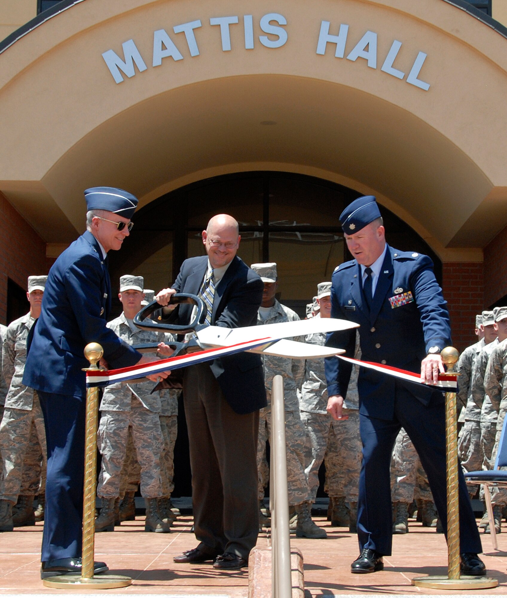 At the Mattis Hall dedication ceremony May 19 in honor of Capt. William Mattis, a fallen B-57 pilot, Brig. Gen. Richard Devereaux, the 82nd Training Wing commander, and Lt. Col. Thomas Ventriglia, the 363rd Training Squadron commander, assist Dr. Charles Mattis, the son of Captain Mattis, with cutting the ribbon. Mattis Hall is a new $27 million, 300-room dormitory for the 363rd Training Squadron. (U.S. Air Force photo/Mike Litteken)