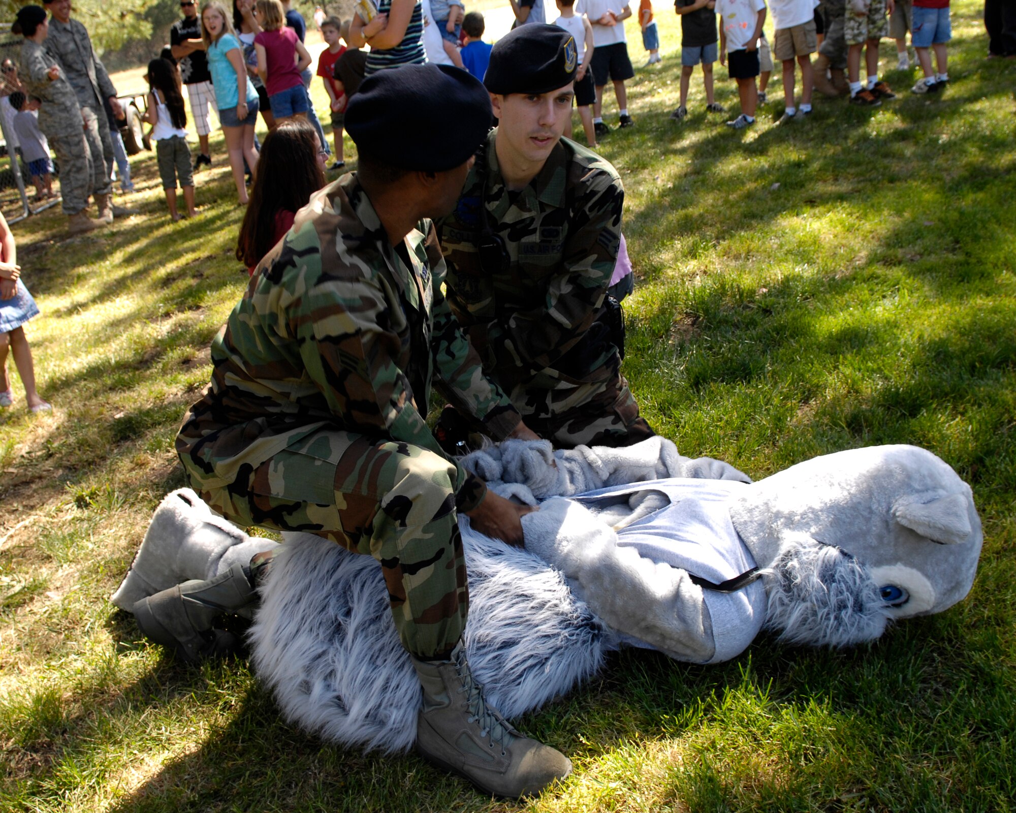 Members of the 30th Security Forces Squadron "arrest" Sammy the Services Squirrel before placing him in a mock Jail during the Police WeekBBQ Friday at Cocheo Park.  (U.S. Air Force photo/Airman 1st Class Jonathan Olds)
