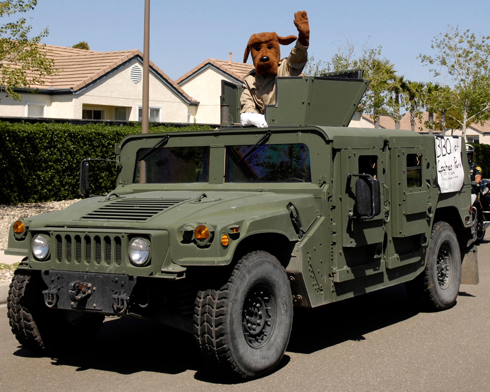 McGruff the Crime Dog waves from a Humvee during the Police Week Parade Friday.  The parade ended at Cocheo Park with a BBQ and activities for Vandenberg families.  (U.S. Air Force photo/Airman 1st Class Jonathan Olds)