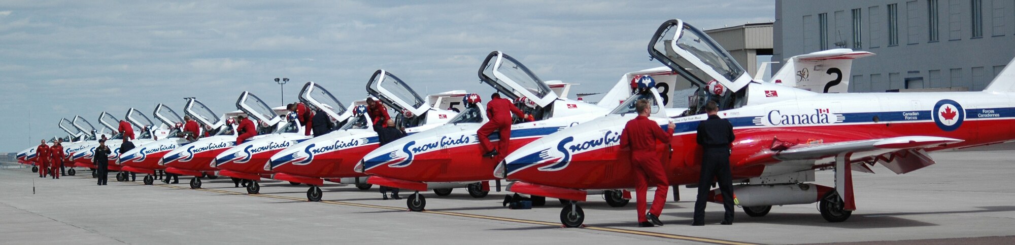 The Canadian Snowbirds Aerial Demonstration Team get out of their aircrafts after landing at Holman Aviation May 15. The Snowbirds performed their 45 minute rountine at this year's Air Show and Open House May 17 and 18. (U.S. Air Force photo/Airman 1st Class Emerald Ralston)