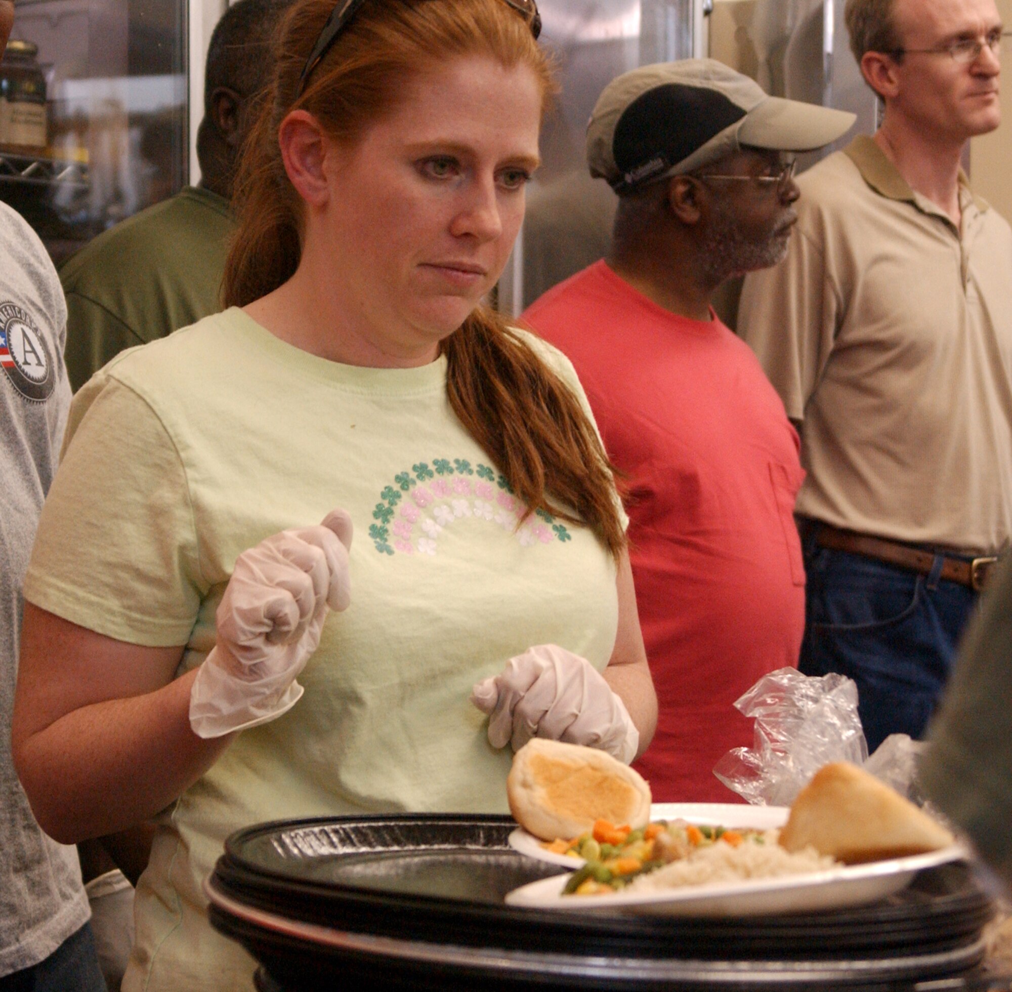 Staff Sgt. Kristine Kays, 99th Medical Operations Squadron magnetic resonance imaging technologist at Nellis Air Force Base, Nev., serves food to homeless veterans during the Las Vegas Homeless Veterans Stand Down Thursday, May 15, 2008. More than 380 veterans were served hot meals during the two day stand down event. (U.S. Air Force photo/Staff Sgt. Aileen Carter)
