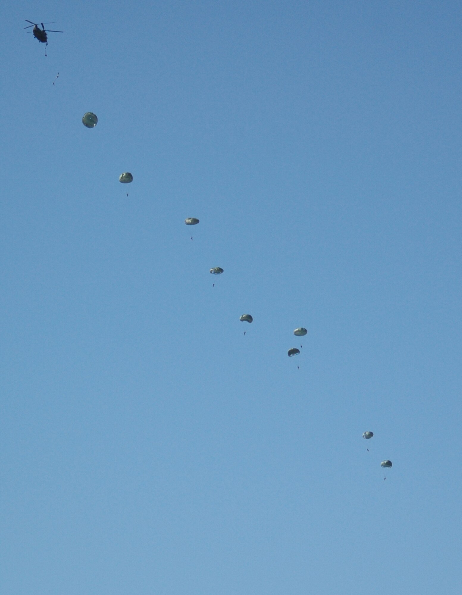 Members of Malmstrom's 819th RED HORSE Squadron Airborne Unit jump from a CH-47 Chinook helicopter during practice for the base's Air Show and Open House May 17 and 18. (U.S. Air Force photo/Airman 1st Class Emerald Ralston)