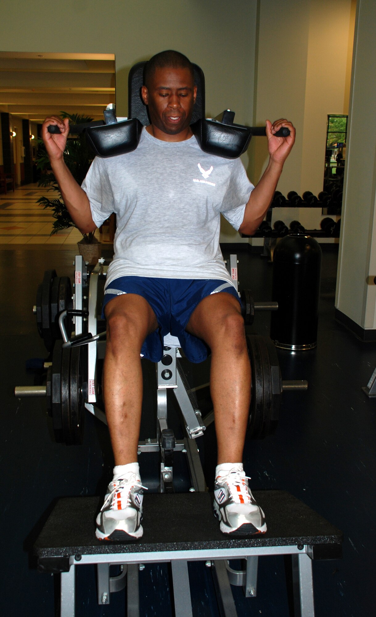 Tech. Sgt. Derrick Grant, 621st Contingency Response Wing command chief exec, gets “Fit to Fight” with the squat machine at the fitness center here recently. (U.S. Air Force photo/Airman 1st Class Rebekah Phy)