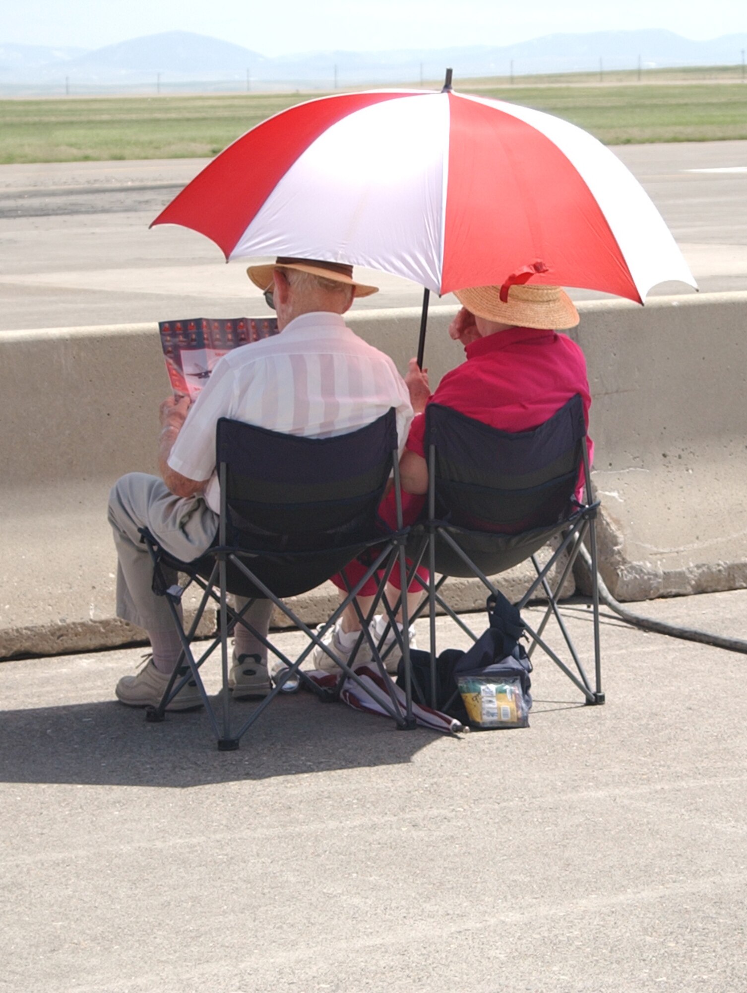Event-goers of all ages took advantage of the chance to see the Canadian Force's Snowbirds Aerial Demonstration Team who were the highlight of the Malsmtrom Air Force Base Air Show and Open House May 17 and 18. This couple takes a moment to look over the Snowbirds information pamphlet just prior to the show. (U.S. Air Force photo/Valerie Mullett)