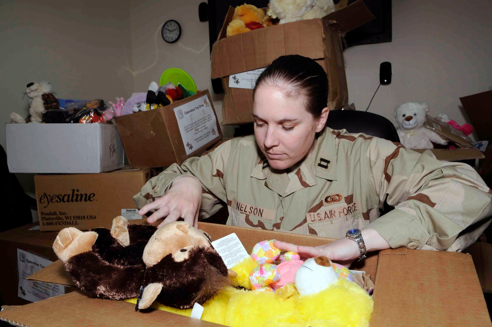 Capt. Nora Nelson takes inventory of the toys that have been collected in an initiative spurred by her niece and nephew to collect toys and games for Iraqi orphans May 16 at a Southwest Asian air base. (U.S. Air Force photo/Tech. Sgt. Johnny Saldivar) 
