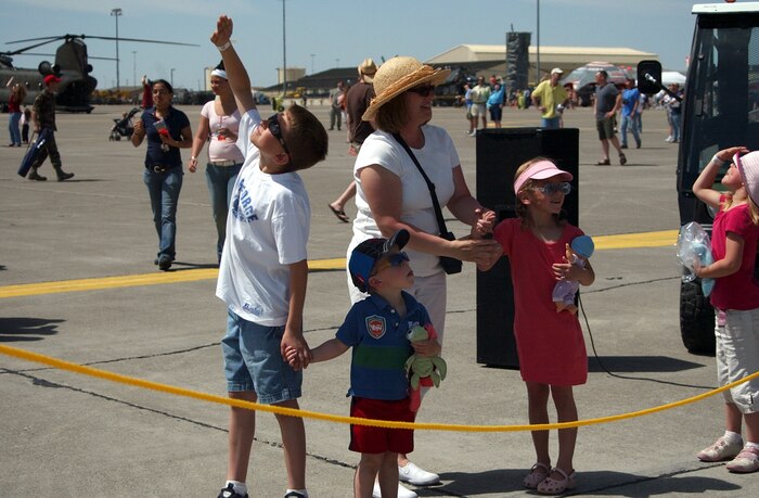 Open house and air show event-goers stop and look to the sky during the A-10 Thunderbolt II"Warthog" and A-1 "Skyrider" Heritage Flight May 17 at Malmstrom Air Force Base, Mont. (U.S. Air Force photo/Valerie Mullett)