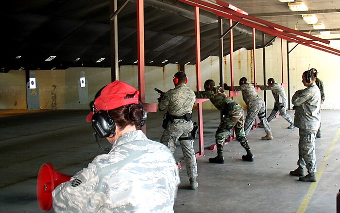 Airmen from the 437th Security Forces Squadron shoot M-9 handguns at the base shooting range May 13. 437 SFS held a shoot-out during a small arms firing competition between local, federal and state law enforcement officers to foster camaraderie and esprit de corps. (U.S. Air Force photo/Tech. Sgt. Christine Smalls)