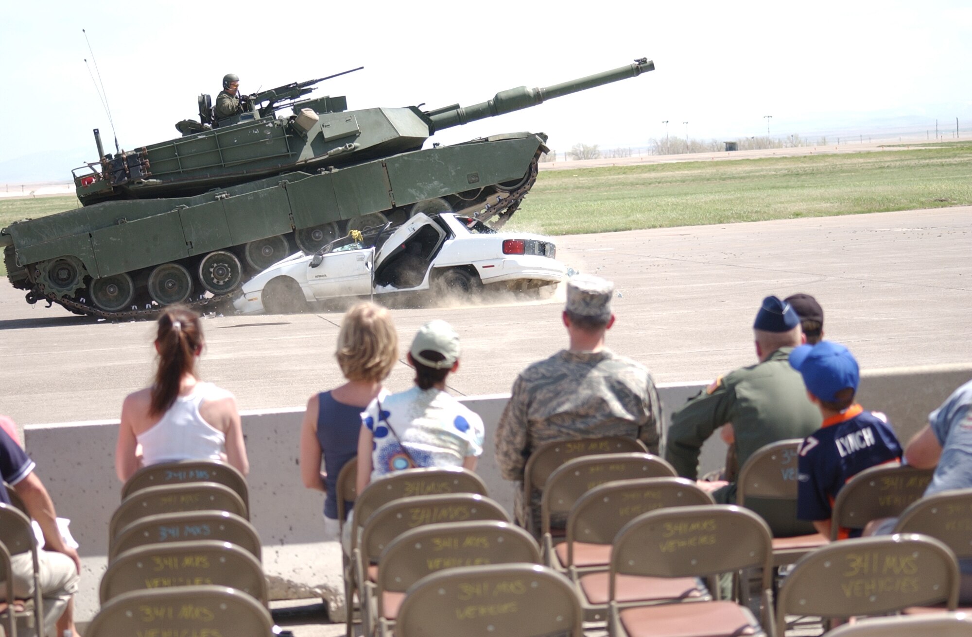An M1A1 tank from the Montana Army National Guard, runs over a car at the end of a demonstration during Malmstrom Air Force Base's air show and open house May  17. (U.S. Air Force photo/Valerie Mullett)