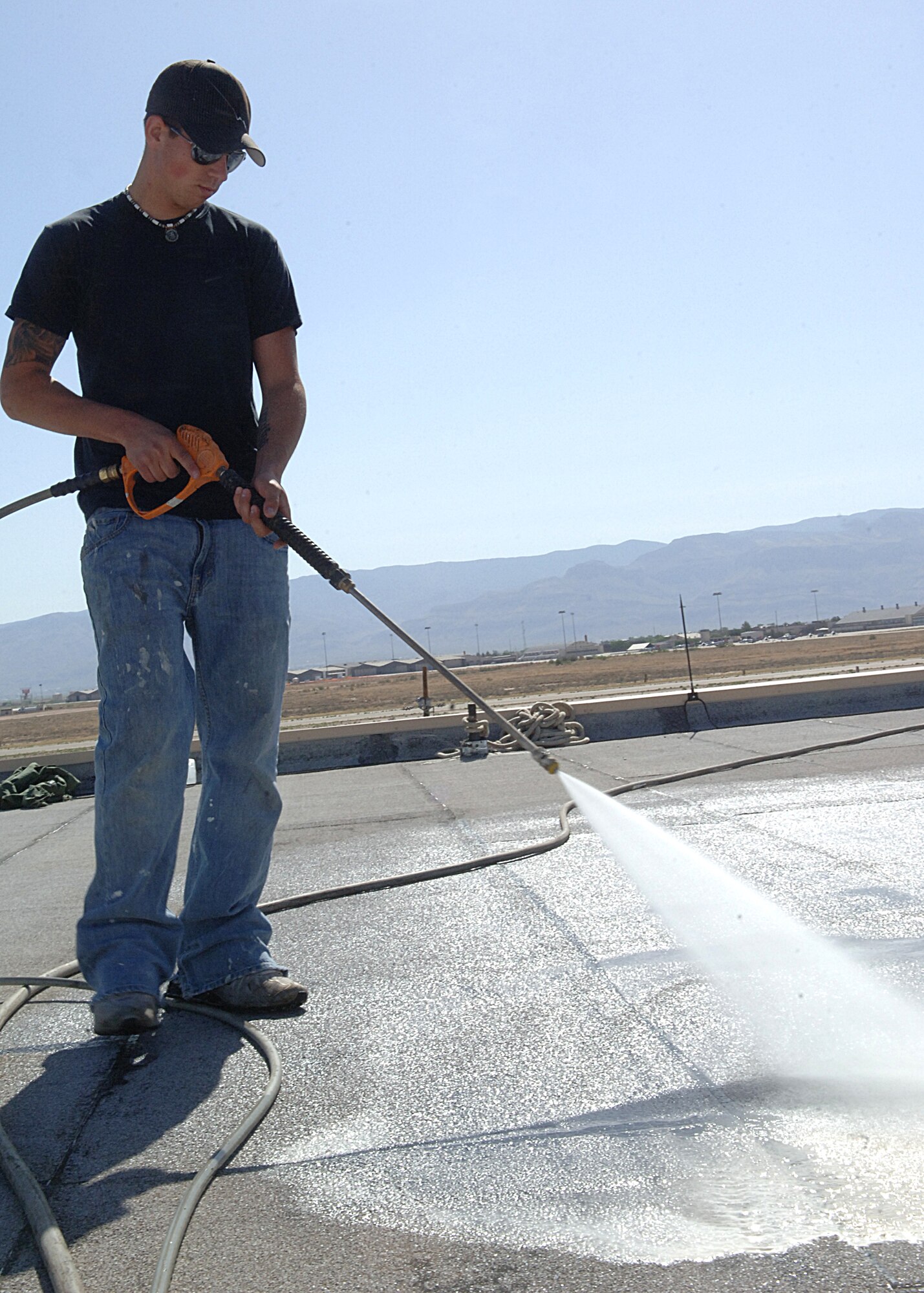 Airman First Class Brian McMahon of the 49th Aircraft Maintenance Squadron power washes the roof of hangar 877 on May 13.  (U.S. Air Force photo/Airman 1st Class John D. Strong II)  