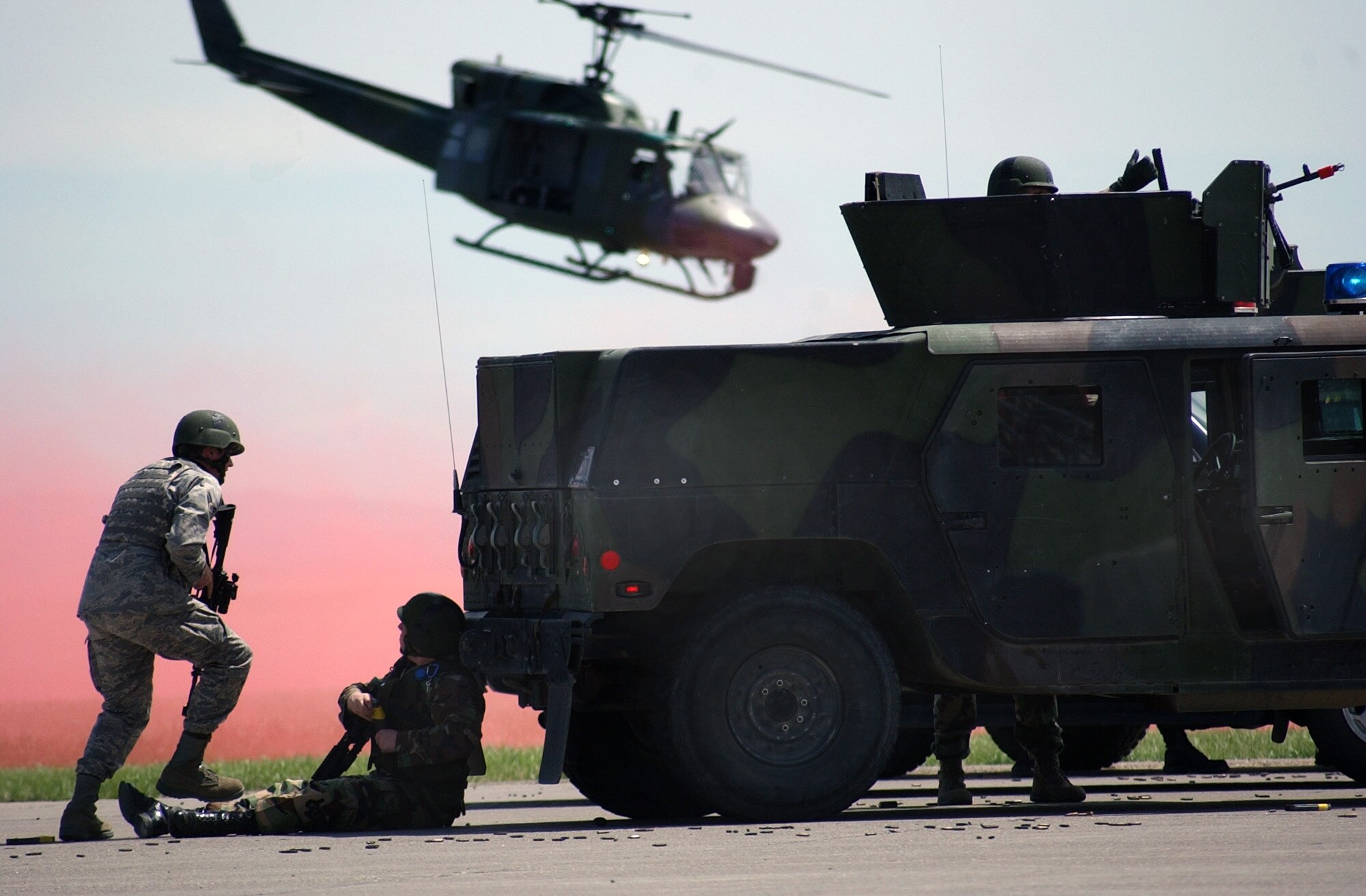 A UH-1N "Huey" helicopter hovers close by the Malmstrom Tactical and Convoy Response teams during a demonstration of force at the 2008 Malmstrom Air Show and Open House May 18. (U.S. Air Force photo/Airman 1st Class Dillon White)