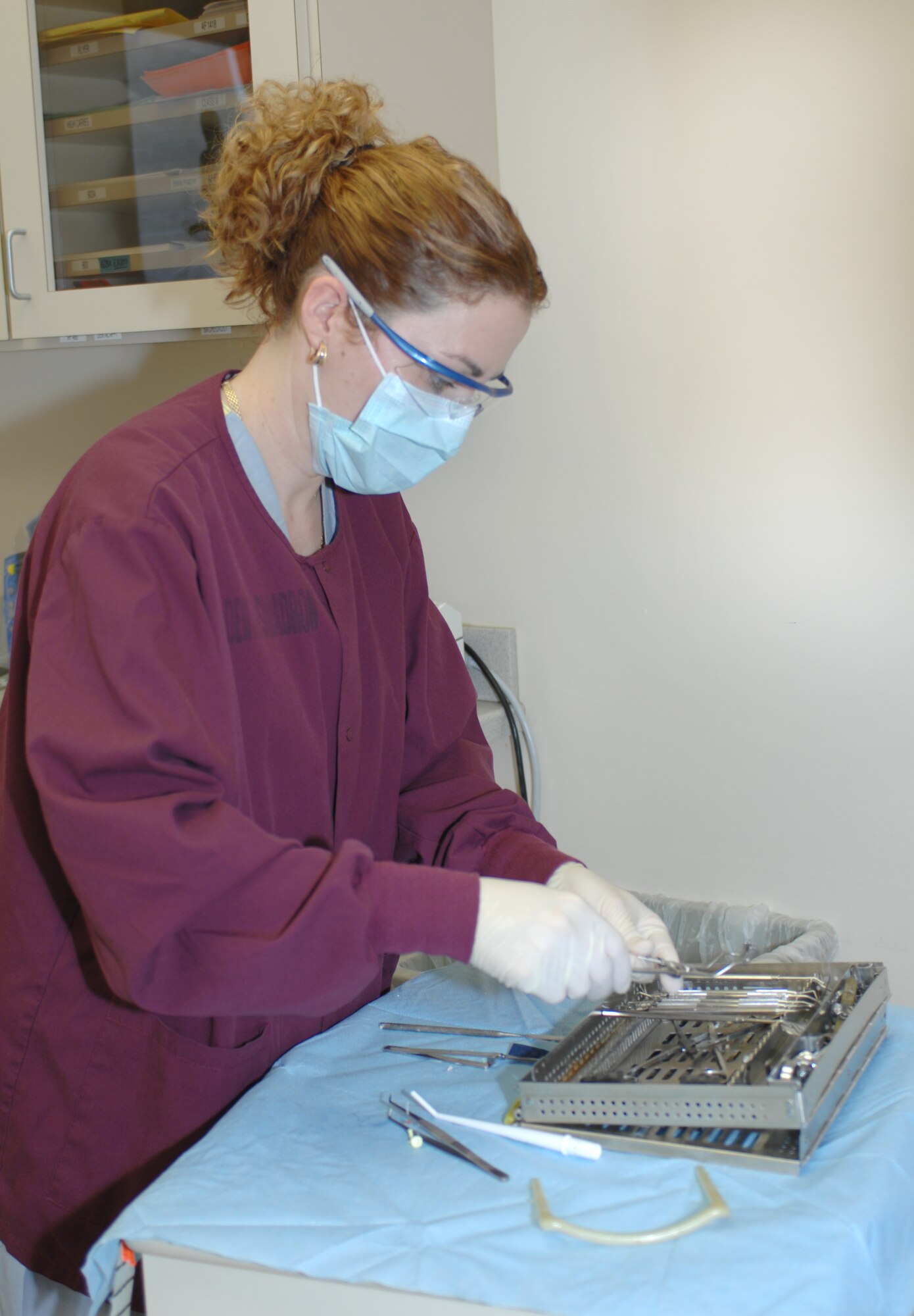 LANGLEY AIR FORCE BASE, Va. -- Mrs. Shelia Medina, an American Red Cross dental assistant program volunteer, prepares dental tools for sanitization after assisting with a root canal here May 19. (U.S. Air Force photo/Tech. Sgt. April Wickes)