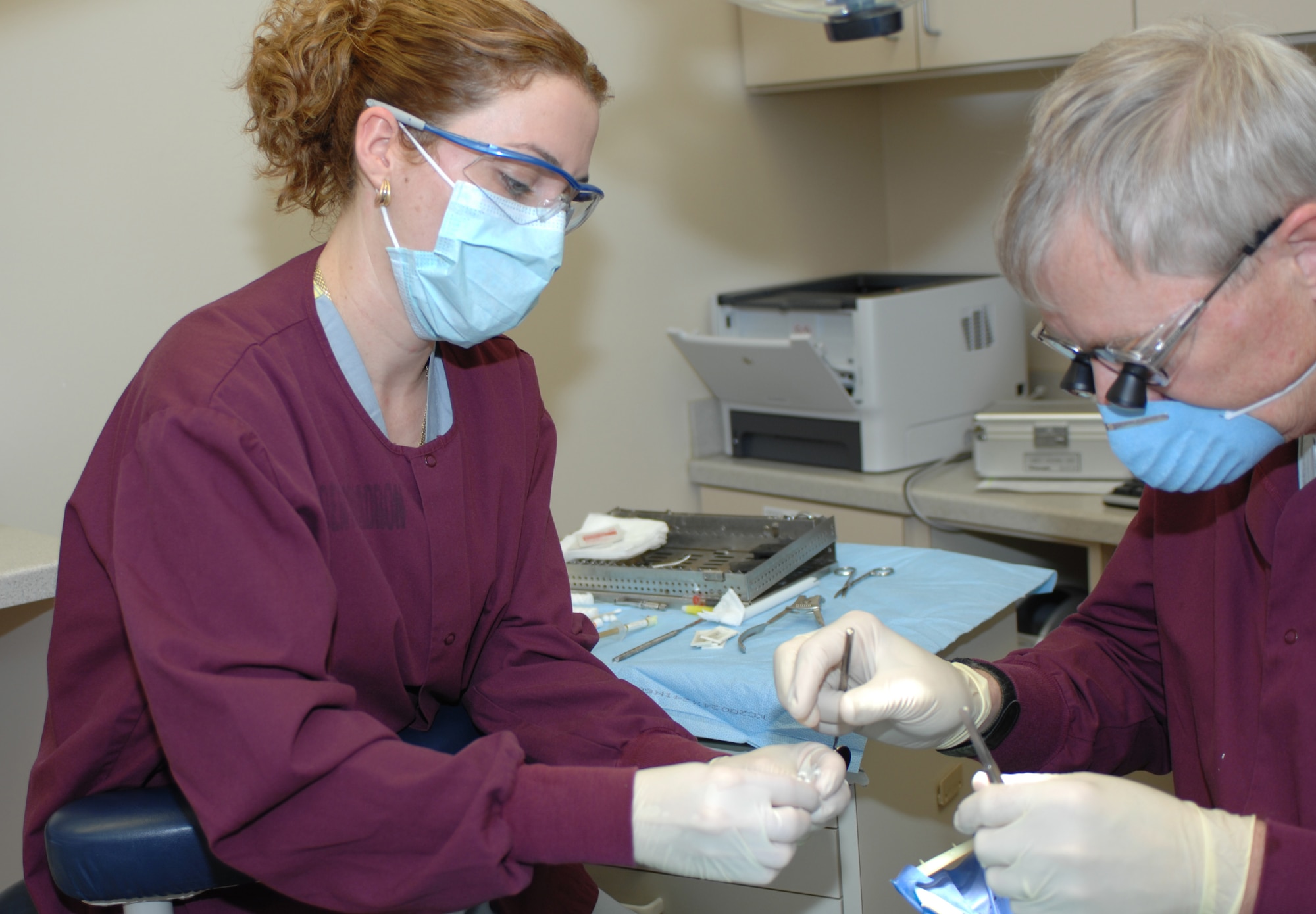 LANGLEY AIR FORCE BASE, Va. -- Mrs. Shelia Medina, an American Red Cross dental assistant program volunteer, assists Dr. James Waring, a dental surgeon from the 1st Dental Squadron, with a root canal here May 19. (U.S. Air Force photo/Tech. Sgt. April Wickes)