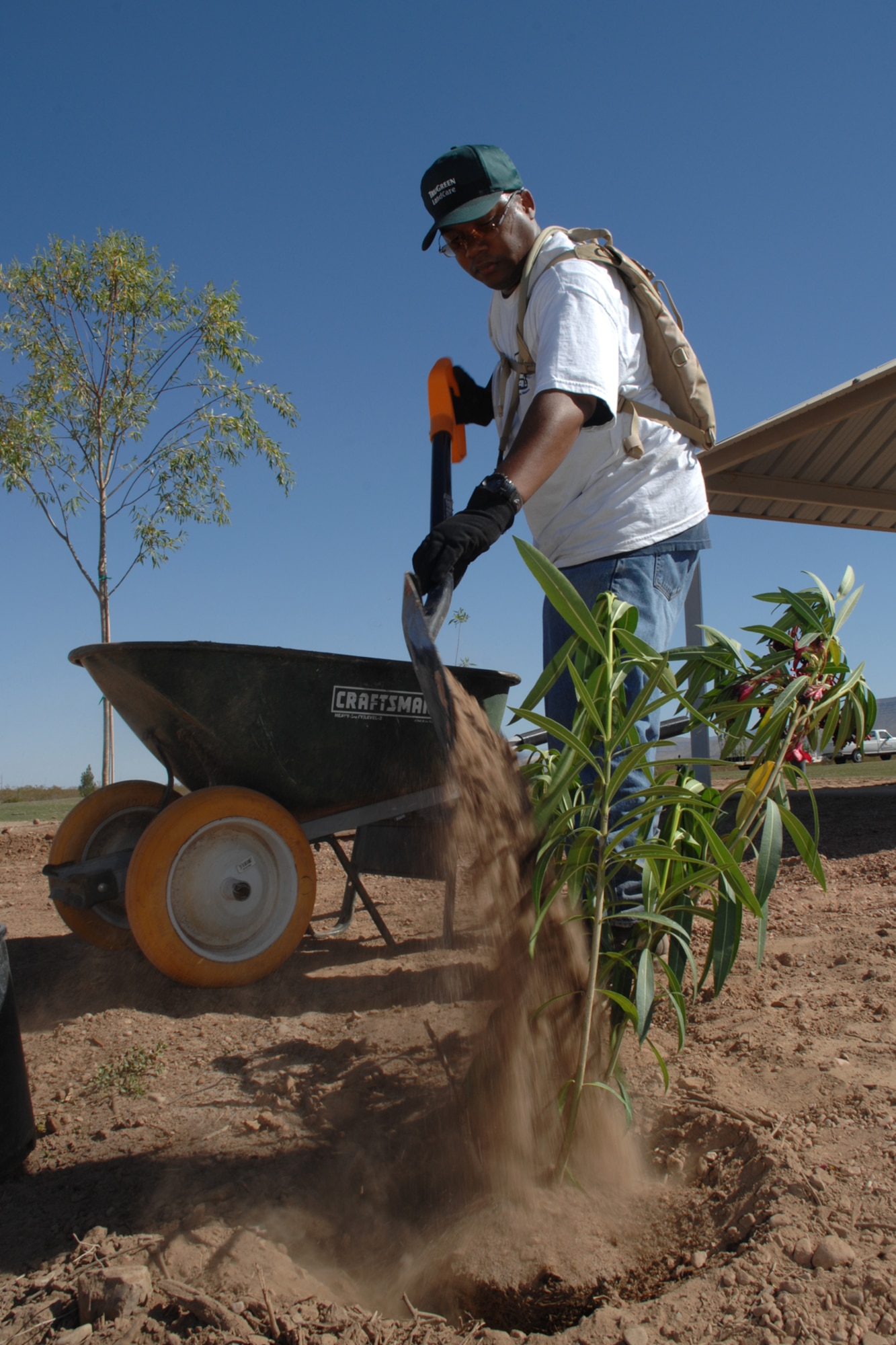 Tech. Sgt. Delano Hill, 49th Aircraft Maintenance Squadron, adds soil to a shrub May 6 at Tierra De Suenos Park in Alamogordo, N.M. Seargent Hill was one of 15 49th Maintenance Group personnel who volunteered to plant trees and shrubs at the park. (U.S. Air Force photo/Airman 1st Class Jamal D. Sutter)