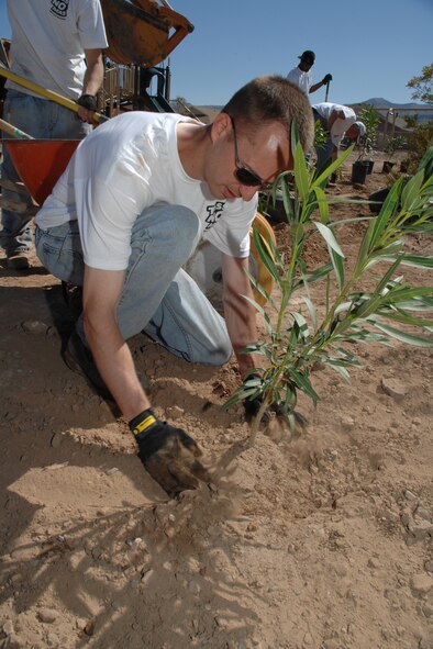 Tech. Sgt. Robin Walker, Keep Alamogordo Beautiful Holloman volunteers project manager, evens soil May 6 at Tierra De Suenos Park in Alamogordo, N.M. The 49th Maintenance Group has over 120 volunteers doing work around the community this summer while awaiting the arrival of the F-22A Raptor. (U.S. Air Force photo/Airman 1st Class Jamal D. Sutter)