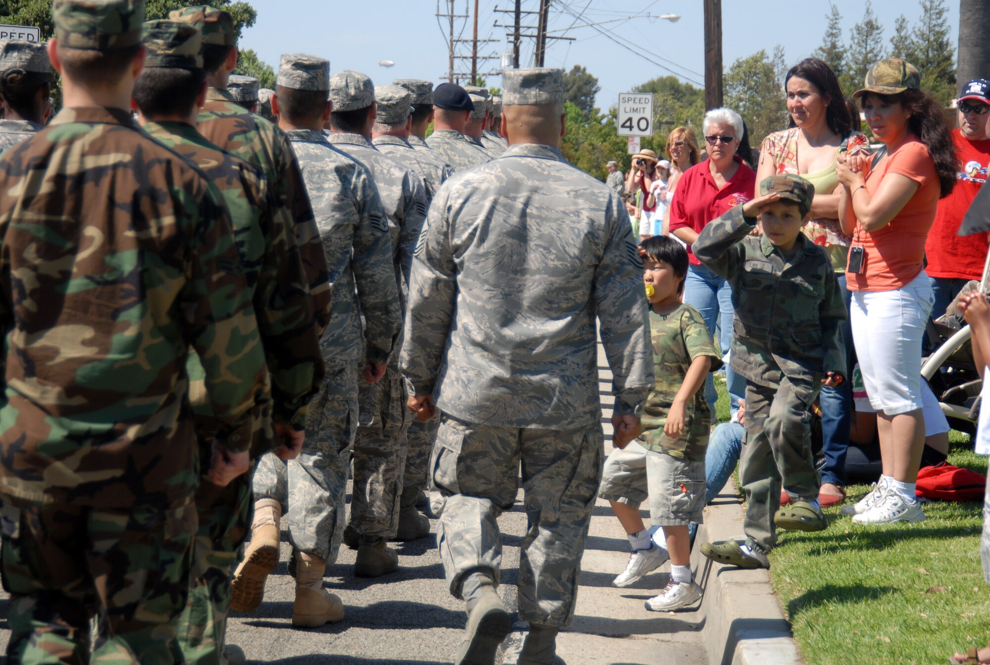 Children salute the Air Force contingent during the 49th Annual Torrance Armed Forces Day celebration in Torrance, Calif., on May 17. The celebration featured various events and military exhibits including aircraft, vehicles and support equipment. (Air Force photo by Senior Airman Julius Delos Reyes)