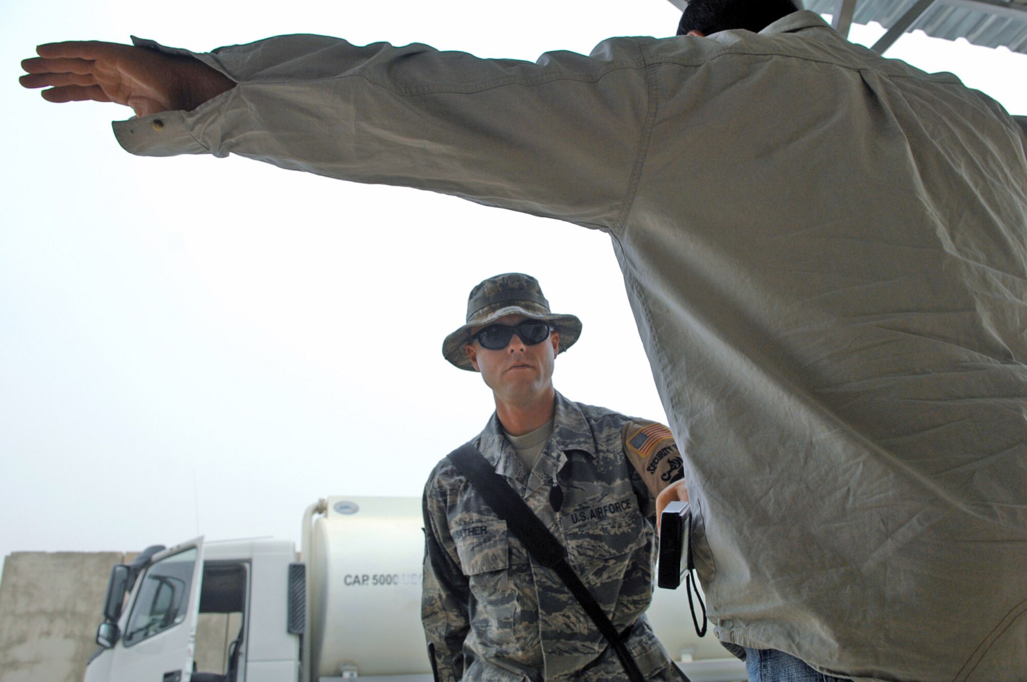 Staff Sgt. Shawn Sather uses a wand to determine if a vehicle driver is carrying concealed items May 17 at Balad Air Base, Iraq. Preventing unauthorized items from entering the base via vehicles or personnel ensures the safety of those assigned to the base. Sergeant Sather is a 332nd Expeditionary Security Forces Squadron force protection inspector deployed from Luke Air Force Base, Ariz. (U.S. Air Force photo/Senior Airman Julianne Showalter) 
