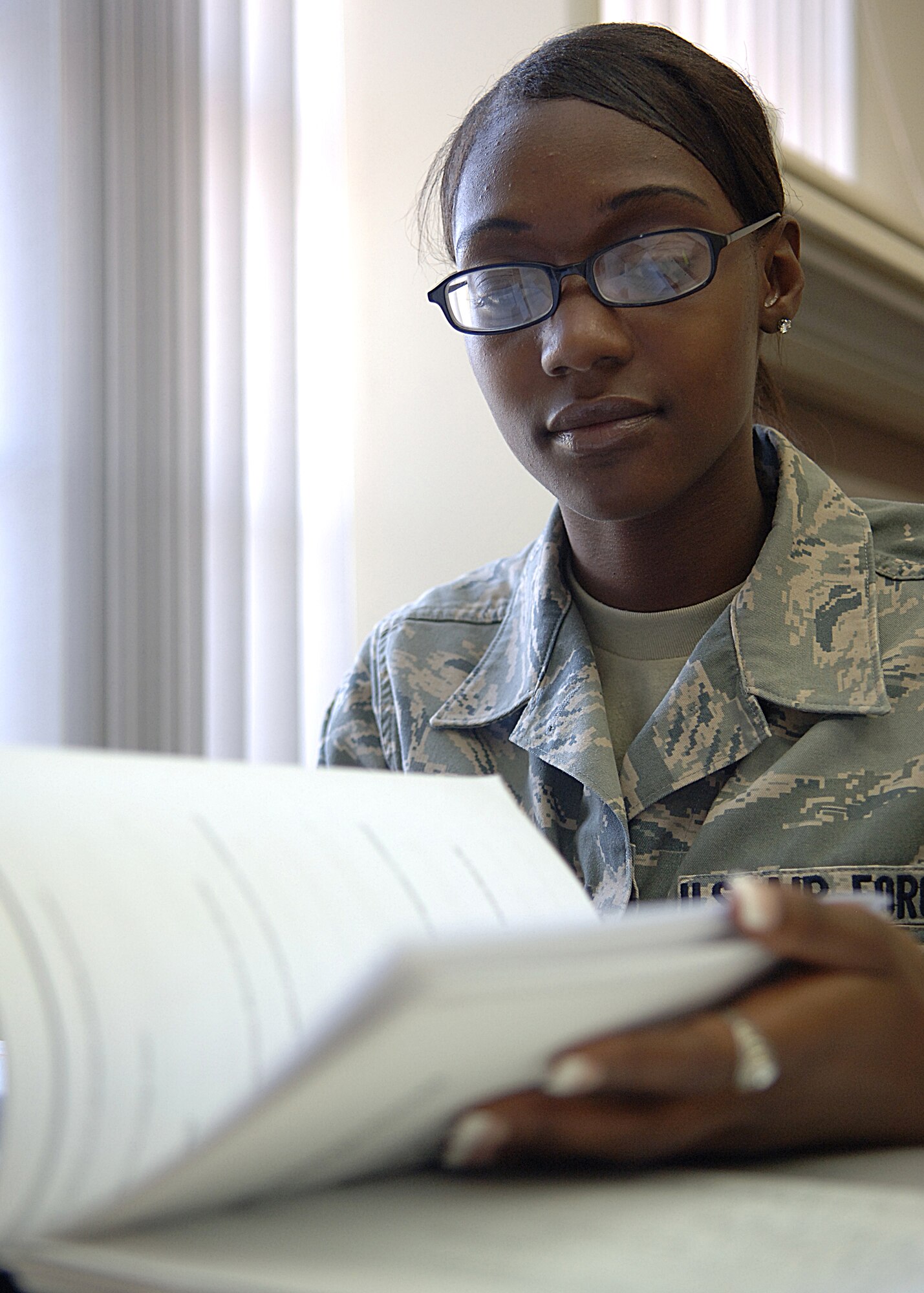Airman First Class Trenise Eldridge of the 49th Operations Group looks diligently for the answer to one of her Career Development Course answers on Holloman Air Force Base, N.M. May 12.  New information manager's that come to Holloman participate in immersion training, which means they train at the Network Training Center, Network Control Center and records management.  (U.S. Air Force photo/Airman 1st Class John D. Strong II)    