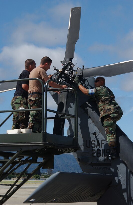 Aircraft maintenance specialist Staff Sgt. Dave Wakefield, Senior Amn Kurt Simmers and Tech. Sgt. Charles Pangelinan, of the 129th Maintenance Group at Moffett Federal Airfield, Calif., performs maintenance on a HH-60G Pave Hawk helicopter rotor blades during an Operation Readiness Exercise. (U.S. Air Force photo by Master Sgt. Dan Kacir) (RELEASED)