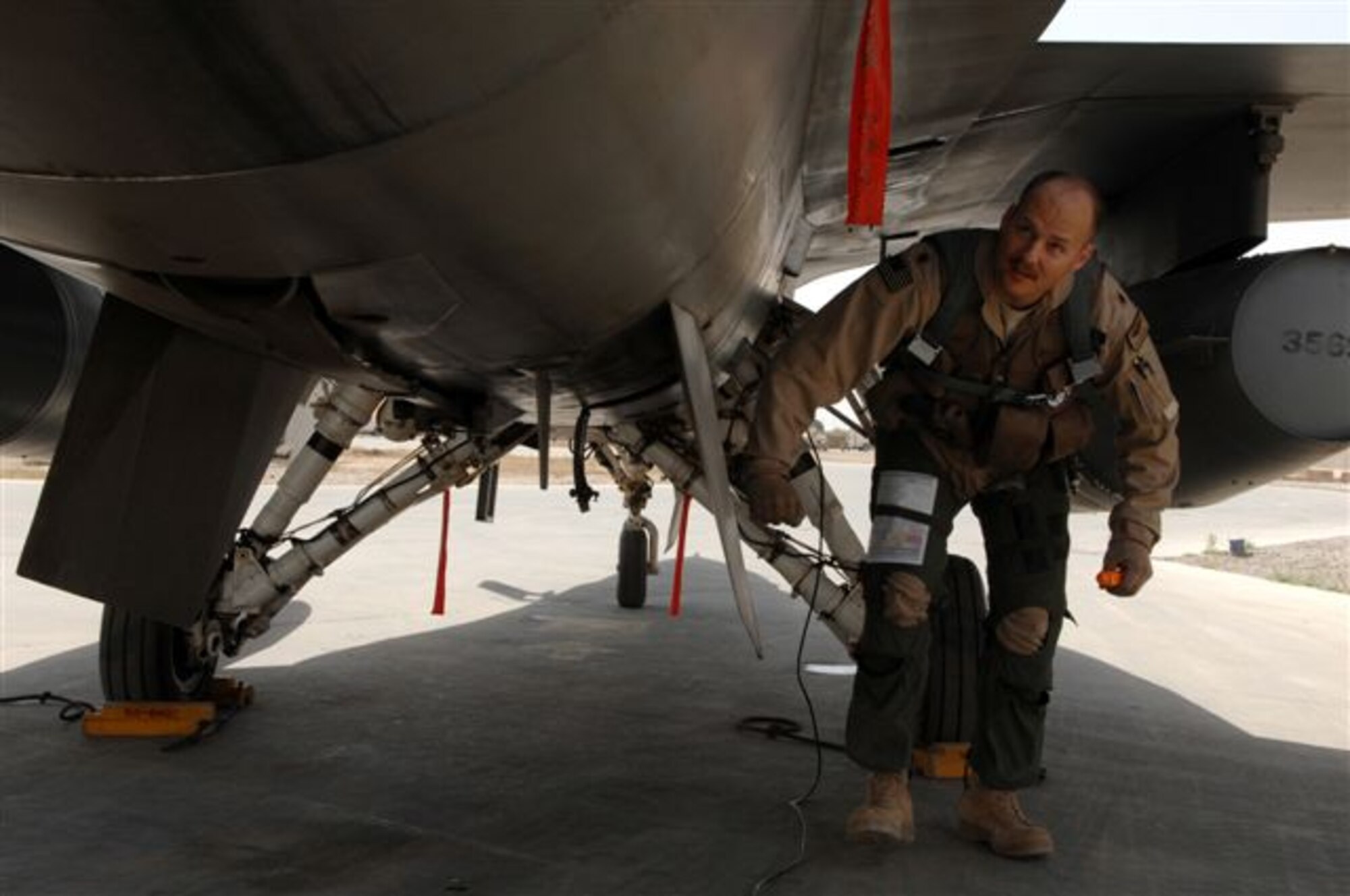 Maj. Dag Grantham, a 332nd Expeditionary Fighter Squadron F-16 Fighting Falcon pilot at Balad Air Base, Iraq, performs a pre-flight inspection on his aircraft prior to a mission. Part of the pre-flight inspection includes checking all maintenance panels to make sure they are closed and fuel tank caps are secured. The F-16 is a compact, multi-role fighter aircraft which is highly maneuverable and has proven itself in air-to-air combat and air-to-surface attack.  Major Grantham is deployed from Luke Air Force Base, Ariz. (U.S. Air Force photo/Senior Airman Julianne Showalter)