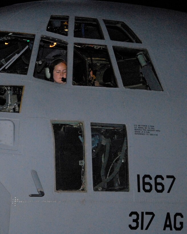 Capt. Nancy Badgett goes through her preflight checklist before engine start-up May 13 at a Southwest Asian air base. Captain Badgett was the aircraft commander of a mission that dropped off and picked up Soldiers and civilians to and from an air base in Iraq. Captain Badgett is a C-130 Hercules pilot with the 737th Expeditionary Airlift Squadron deployed from Dyess Air Force Base, Texas. (U.S. Air Force photo/Tech. Sgt. Michael O'Connor) 
