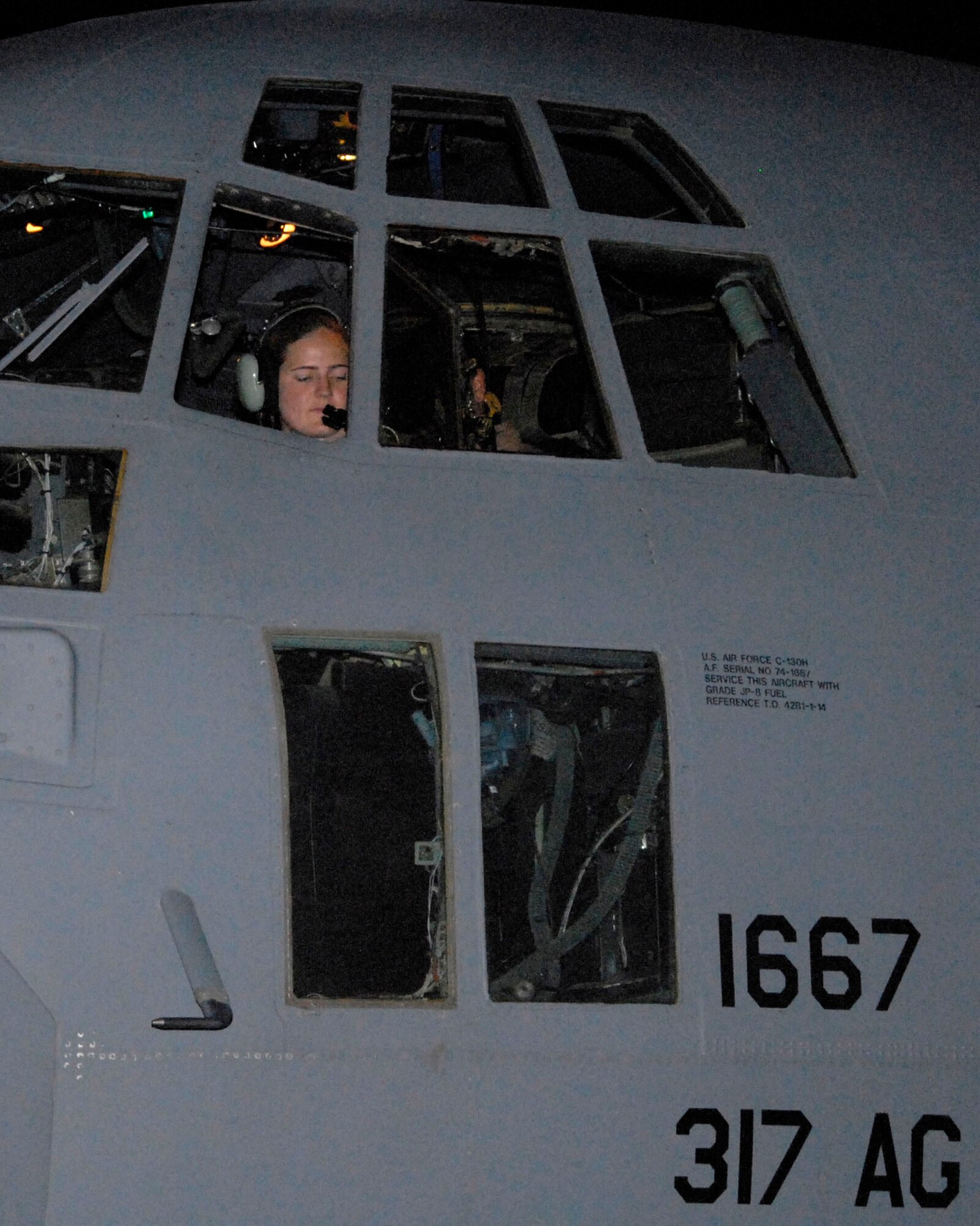 Capt. Nancy Badgett goes through her preflight checklist before engine start-up May 13 at a Southwest Asian air base. Captain Badgett was the aircraft commander of a mission that dropped off and picked up Soldiers and civilians to and from an air base in Iraq. Captain Badgett is a C-130 Hercules pilot with the 737th Expeditionary Airlift Squadron deployed from Dyess Air Force Base, Texas. (U.S. Air Force photo/Tech. Sgt. Michael O'Connor) 
