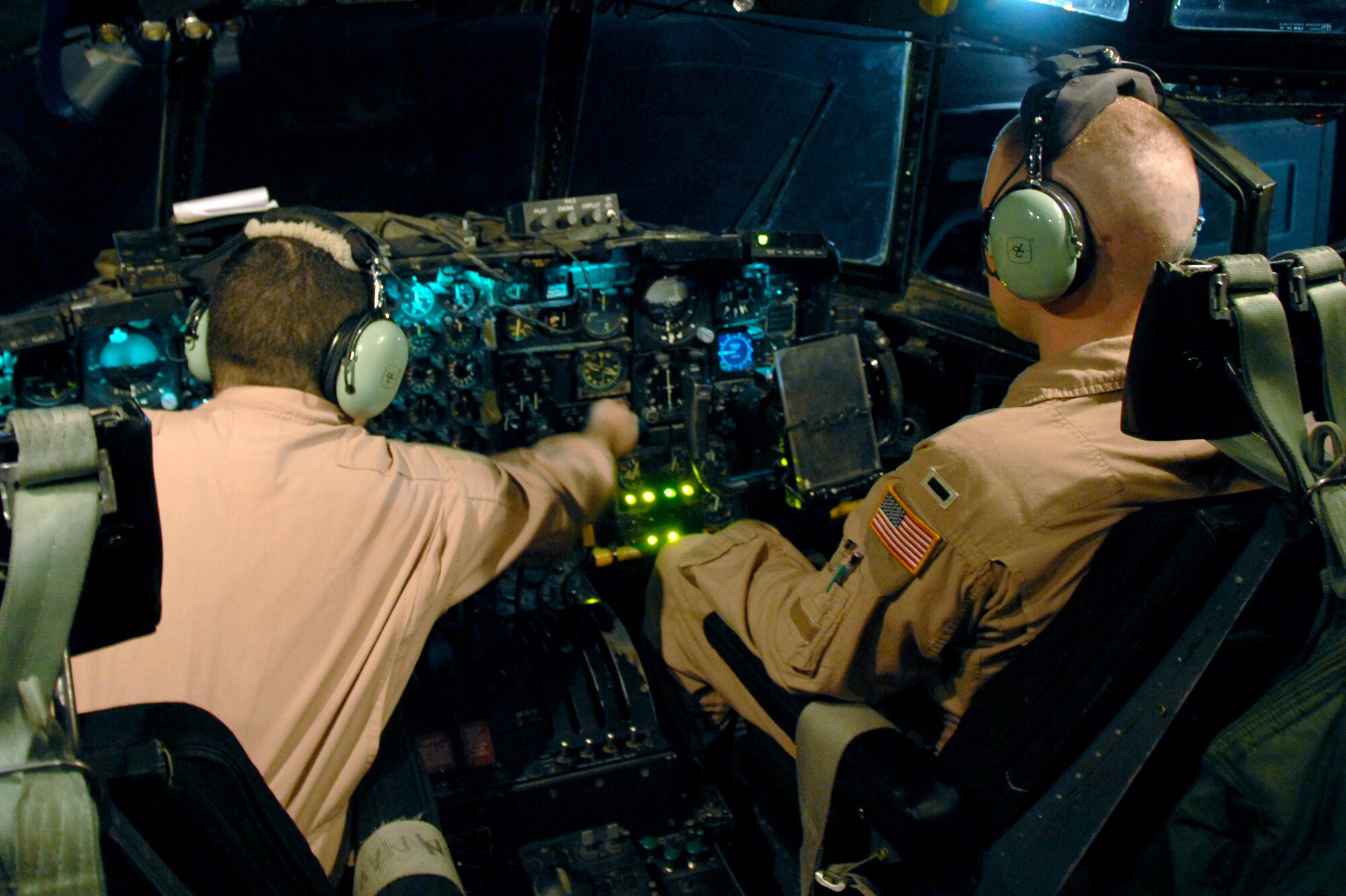 Staff Sgt. James Rice and 1st Lt. Justin Fitzpatrick go through a preflight checklist to ensure all the control and pressure guages are working on the instrument panel prior to a C-130 Hercules departure on a passenger/cargo mission to Iraq May 13. Both Lieutenant Fitzpatrick and Sergeant Rice are deployed from Dyess Air Force Base, Texas. Sergeant Rice is a C-130 Hercules engineer, and Lieutenant Fitzpatrick is a co-pilot with the 737th Expeditionary Airlift Squadron. (U.S. Air Force photo/Tech. Sgt. Michael O'Connor) 
