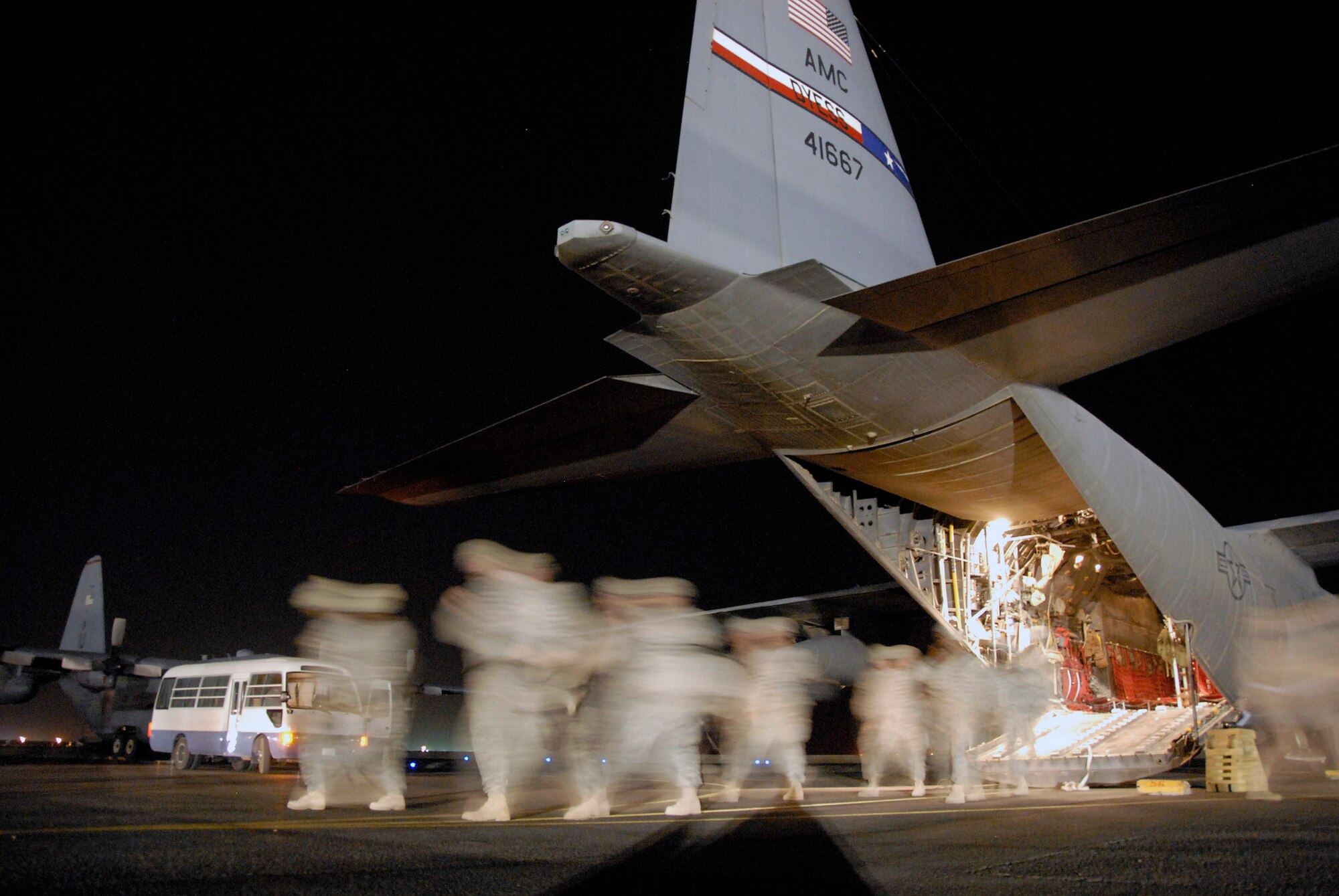 Soldiers returning home from a 14-month deployment in Iraq step-off of a C-130 Hercules May 13 at a Southwest Asian air base. The Soldiers are deployed from the A Battery, 1-10 Field Artillery, 3rd Brigade Combat Team, 31st Division out of Fort Benning, Ga. (U.S. Air Force photo/Tech. Sgt. Michael O'Connor) 
