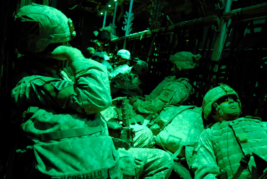 Army 1st Lt. John Costello (front left) and 1st Lt. Ruben Ramos (front right) take a power nap in the back of a C-130 Hercules May 13 after departing an air base in Iraq. The Soldiers are returning home from a 14-month deployment in Iraq and are deployed from the A Battery, 1-10 Field Artillery, 3rd Brigade Combat Team, 31st Division out of Fort Benning, Ga. (U.S. Air Force photo/Tech. Sgt. Michael O'Connor) 