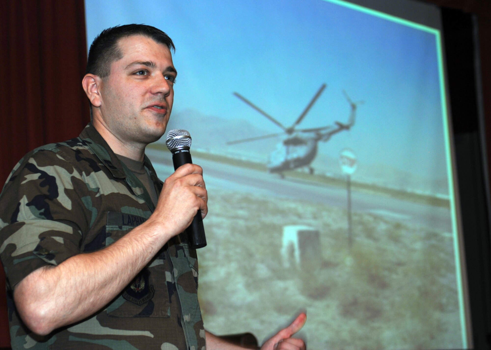 Capt. Matt Lapham presents information and pictures pertaining to his Afghanistan deployment including the challenges of working with foreigners, the language barriers and some of the creative procuring practices they had. (U.S. Air Force photo by Master Sgt. Sarah Frankenhoff)   