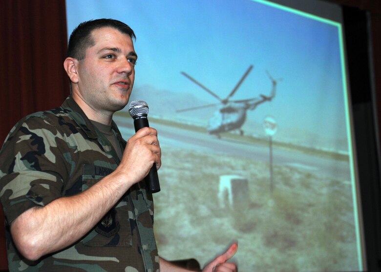 Capt. Matt Lapham presents information and pictures pertaining to his Afghanistan deployment including the challenges of working with foreigners, the language barriers and some of the creative procuring practices they had. (U.S. Air Force photo by Master Sgt. Sarah Frankenhoff)   