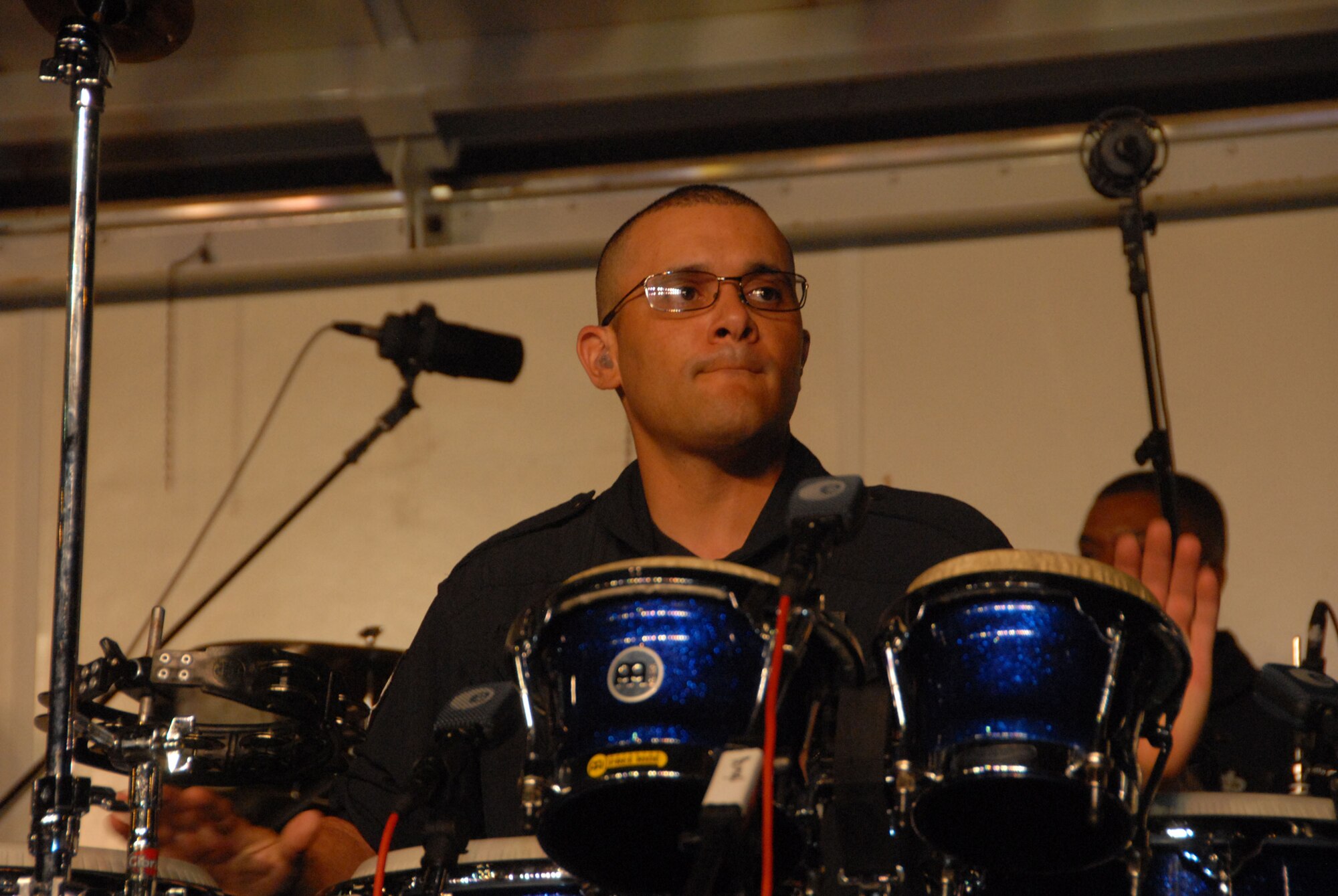 Senior Airman Wilfredo Cruz, a percussionist in the Band of the Air Force Reserve, keeps the beat going while performing at Ft. Buchanan, Puerto Rico. The band opened for Puerto Rican meringue singer Melina Leon there and at Guantanamo Bay Naval Base, Cuba as part of Caribbean Tour 2008. (Air Force photo/Master Sgt. Chance Babin)